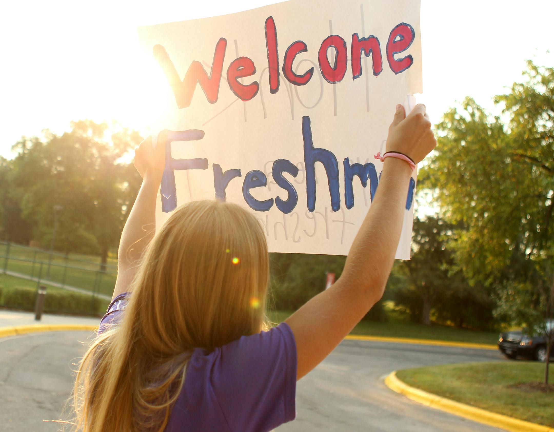 Megan Smith, a junior, holds up a sign a for new students as they arrive for freshman orientation at Visitation High School in Mendota Heights, Minn., on Wednesday, August 21, 2013. ] (ANNA REED/STAR TRIBUNE) anna.reed@startribune.com (cq)