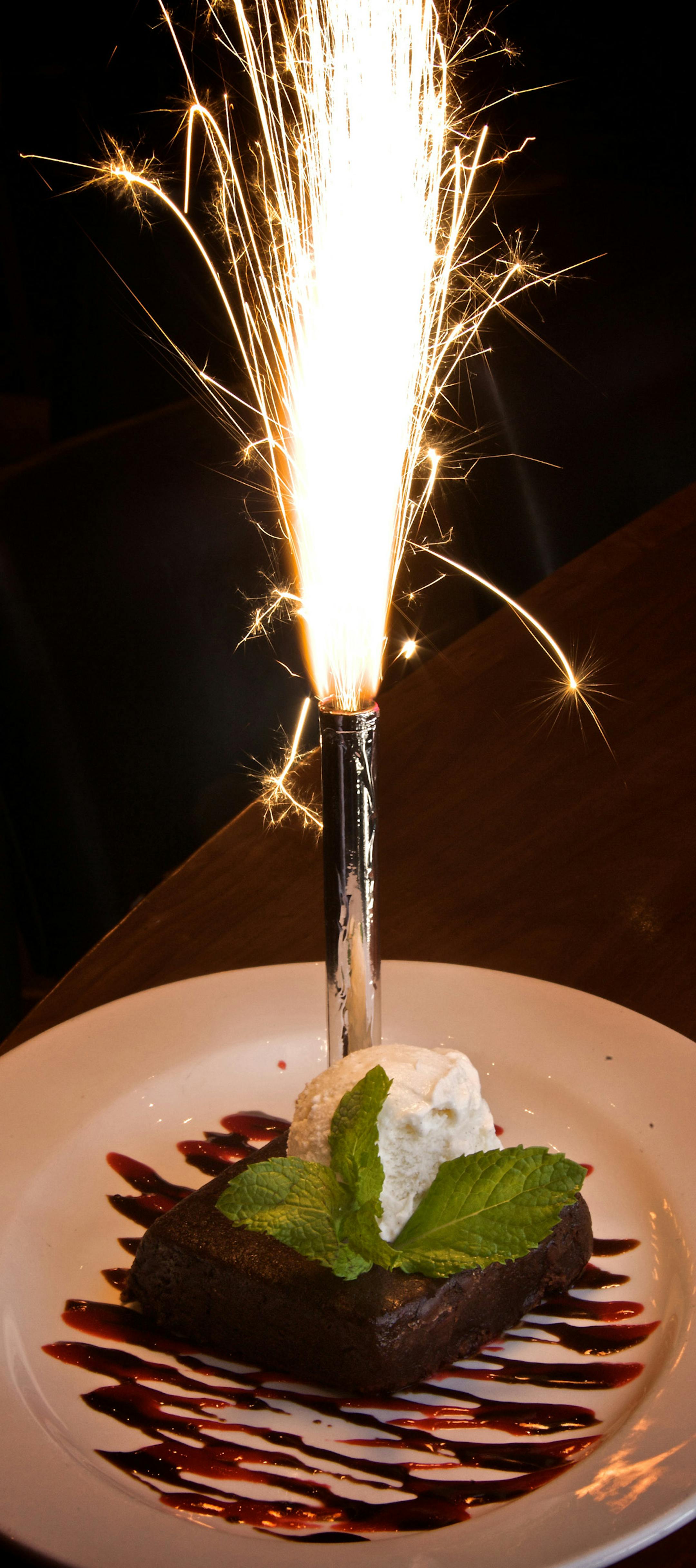 A brownie with vanilla bean ice cream gets the Flame treatment, and then some.