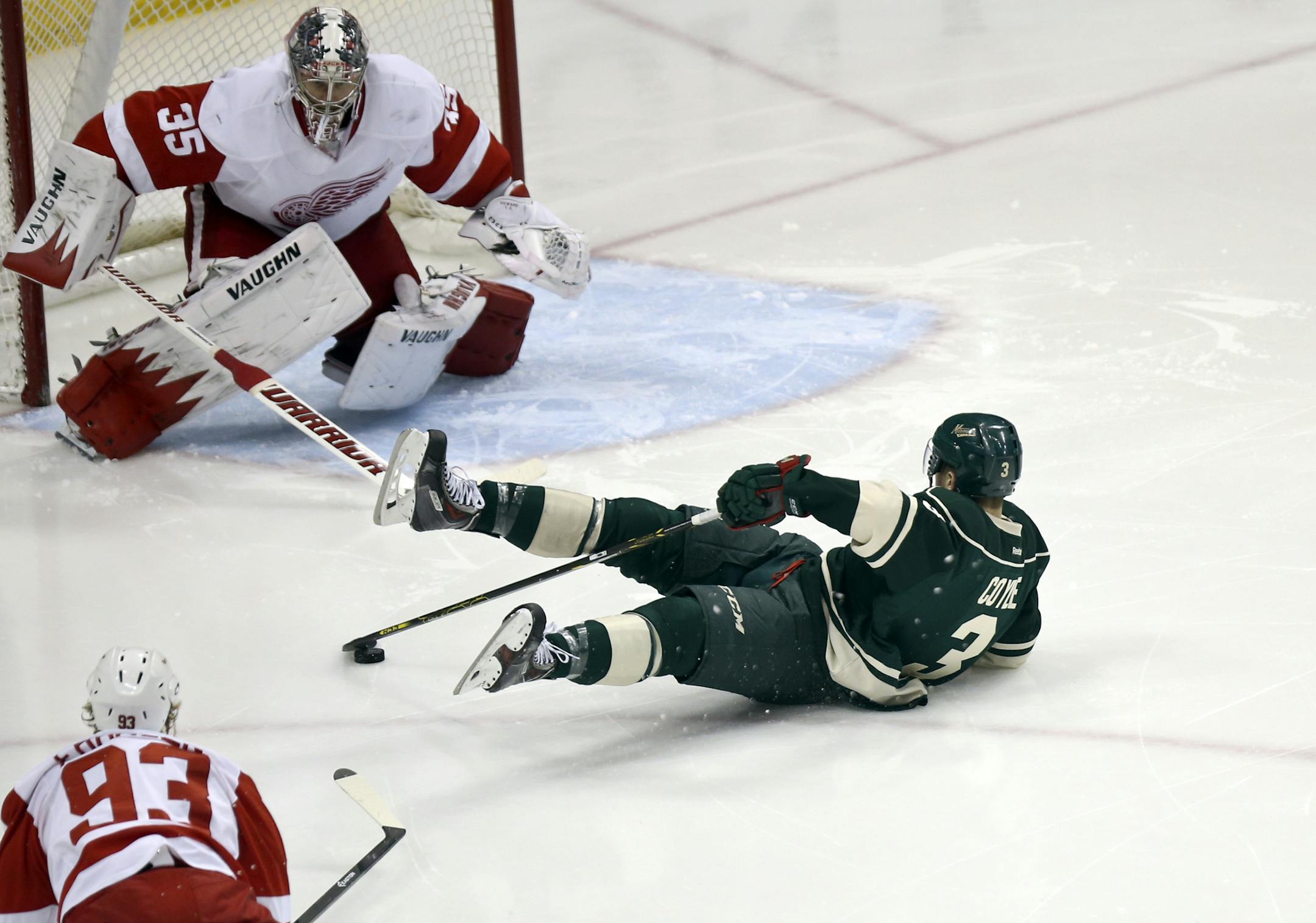After being tripped on a breakaway attempt the Minnesota Wild's Charlie Coyle tries to control the puck while headed towards Detroit Red Wings goalie Jimmy Howard (35) during third period action at the Xcel Energy Center, Saturday, March 22, 2014, in St. Paul, MN. Coyle tied the game on a penalty goal but Detroit beat the Wild 3-2.](DAVID JOLES/STARTRIBUNE) djoles@startribune.com