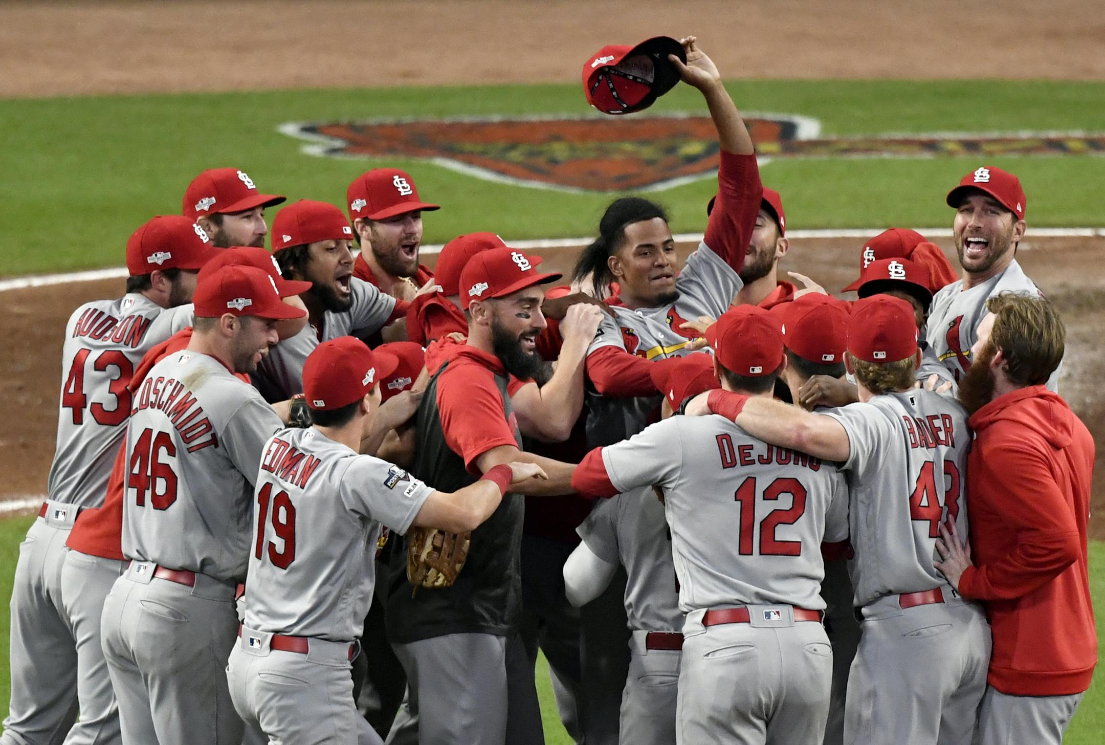 St. Louis Cardinals relief pitcher Genesis Cabrera waves his hat in the air as he celebrates with teammates after the Cardinals beat the Atlanta Braves 13-1 in Game 5 of their National League Division Series baseball game Wednesday, Oct. 9, 2019, in Atlanta. (AP Photo/Danny Karnik)