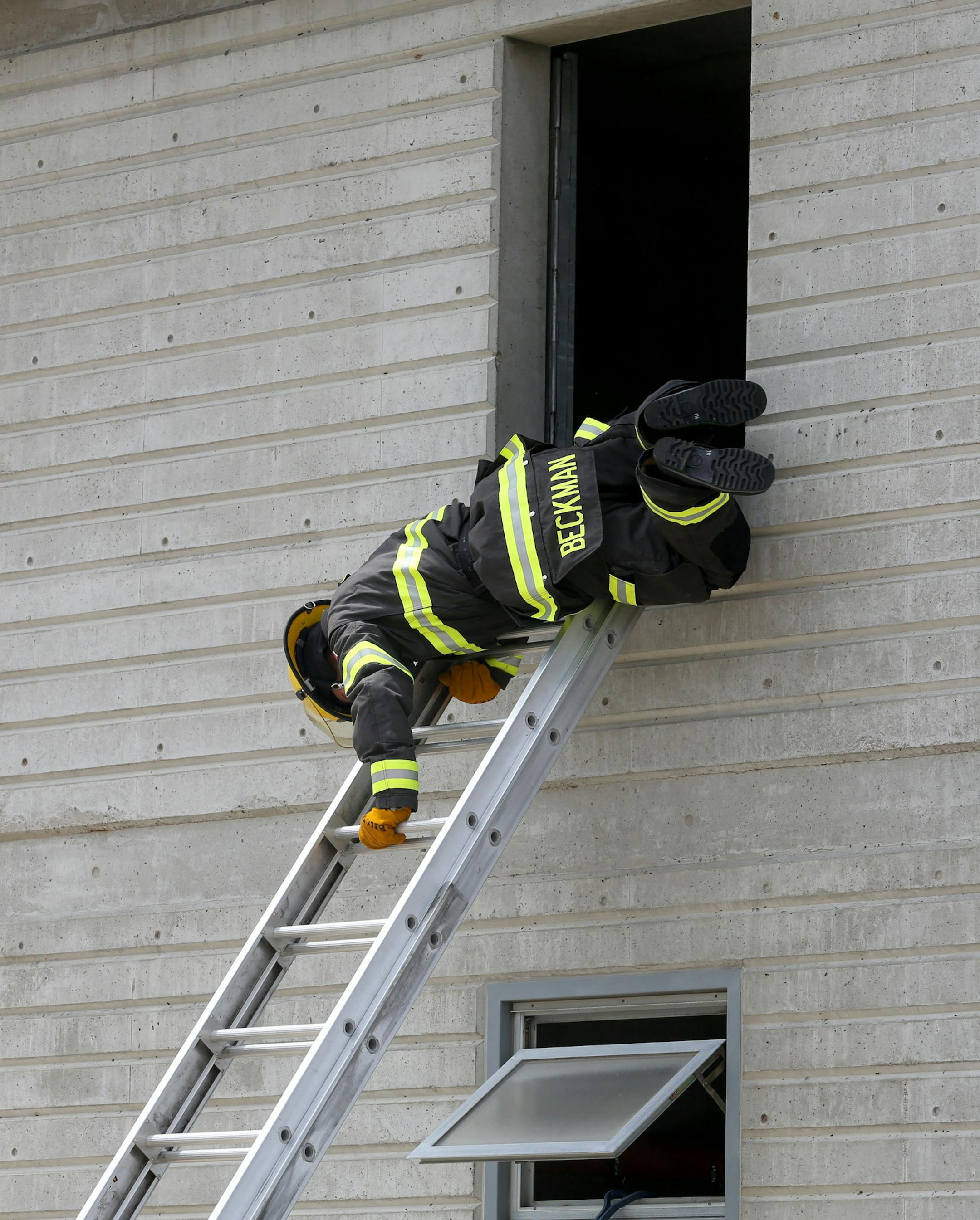 Cadet Lucas Beckman demonstrated a bail out during a skills event in front of family and friends as a part of the graduation ceremony. ] (KYNDELL HARKNESS/STAR TRIBUNE) kyndell.harkness@startribune.com At the NE Emergency Operations Training Facility in Minneapolis, Min. Friday, July 11, 2014. Of the 19 newly minted Minneapolis firefighters, 18 of them are veterans. We talk to some of them and find out if this is part of a concerted effort to hire veterans.