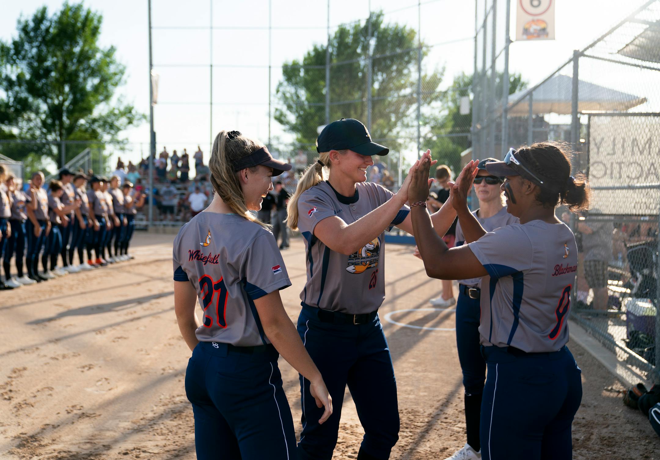 Aussie Peppers' Chelsea Forkin (25), center, gave her teammate Janice Blackman (9) a high-five as she was announced before a game against the Canadian Wild in North Mankato, Minn. Wednesday, July 3, 2019. ] RENEE JONES SCHNEIDER ¥ renee.jones@startribune.com