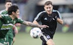 Minnesota United FC's Bashkim Kadri and Portland Timber Zarek Valentin battled for the ball in the first half against the Portland Timbers at Providen