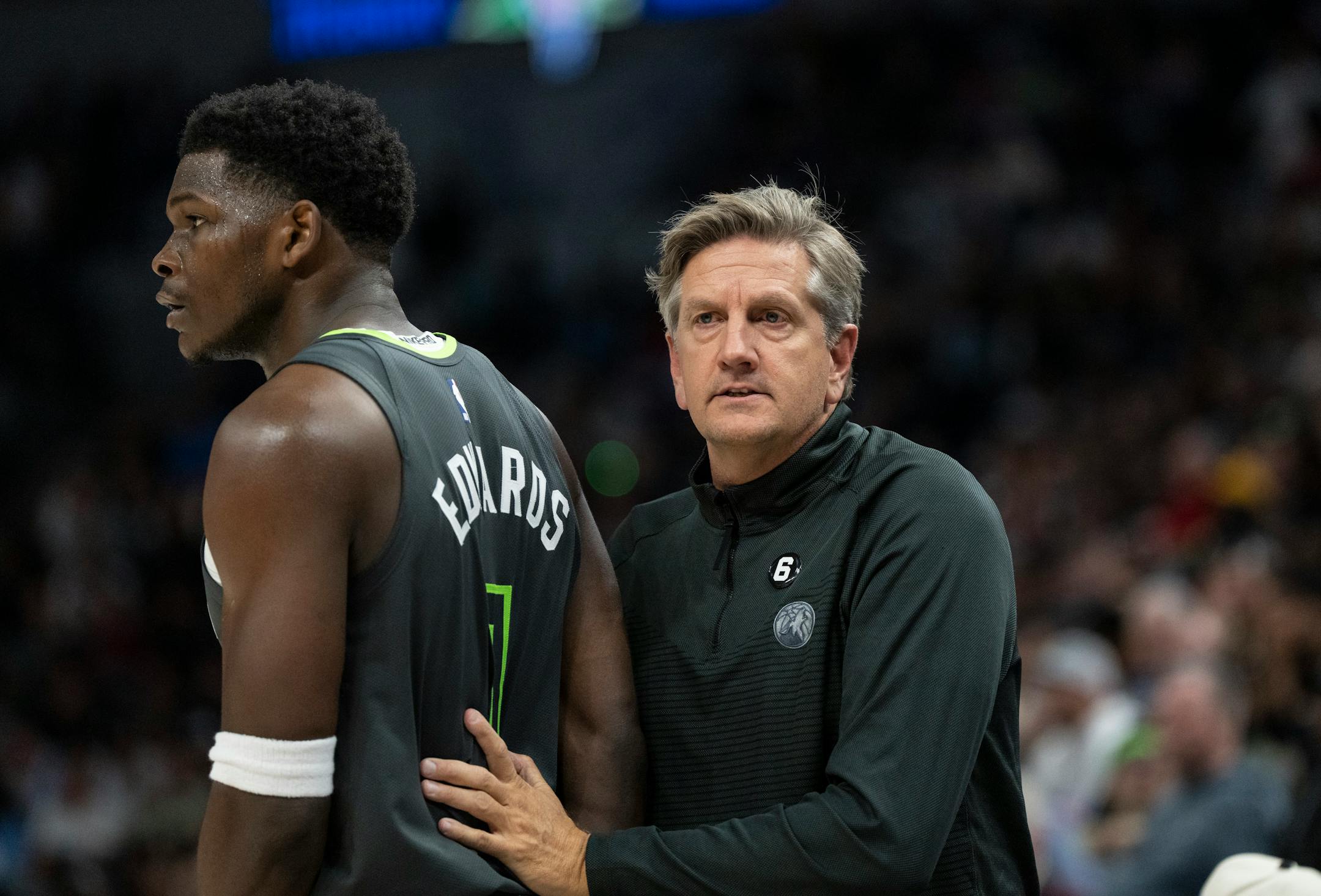 Minnesota Timberwolves head coach Chris Finch pats Minnesota Timberwolves forward Anthony Edwards (1) on the back  in the third quarter.