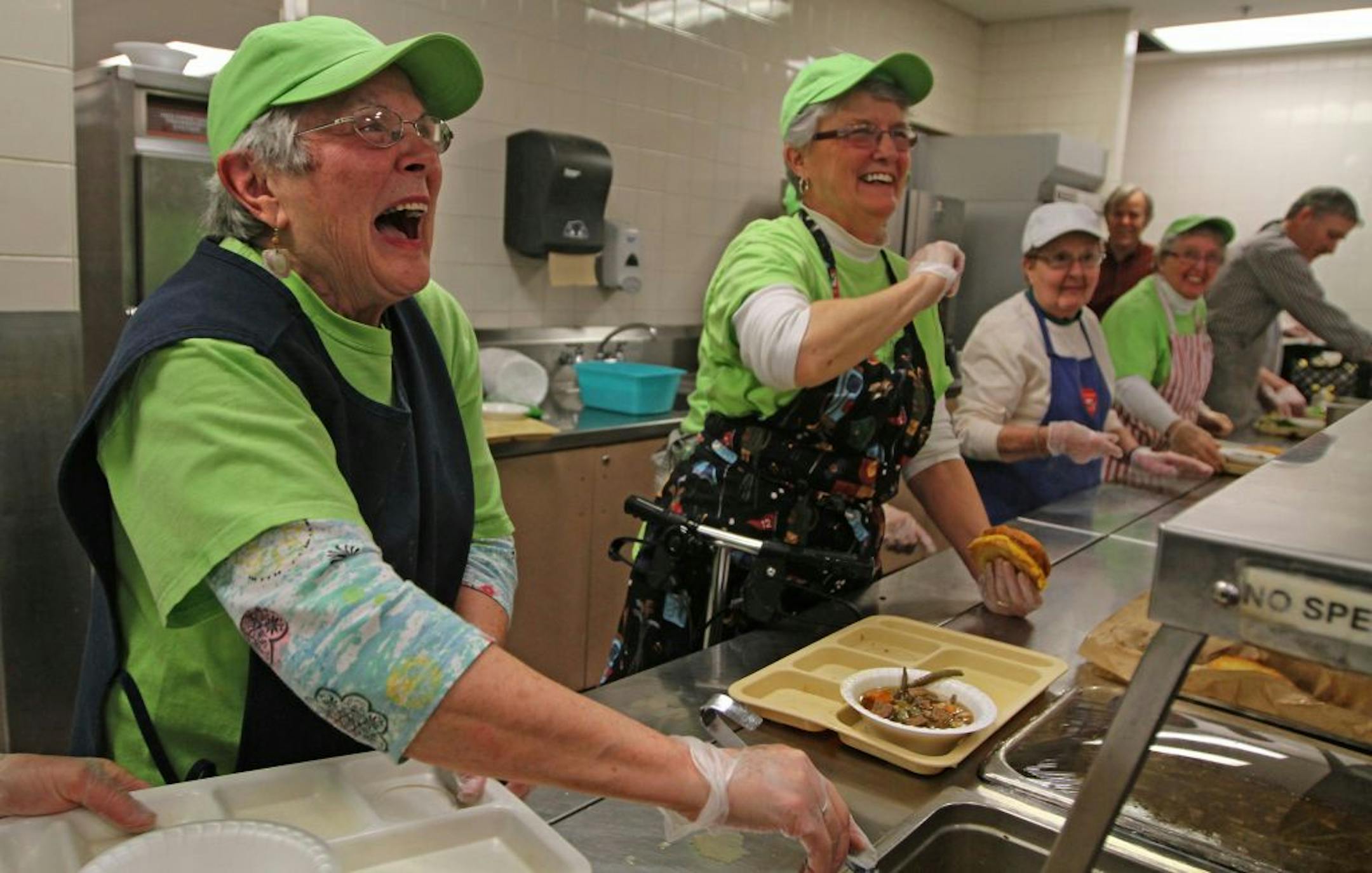 Bobbie Driscoll, left, and Judy Vennewitz greeted regulars in the serving line at St. Paul's Dorothy Day Center, where they were dishing up their last lunches as volunteers.