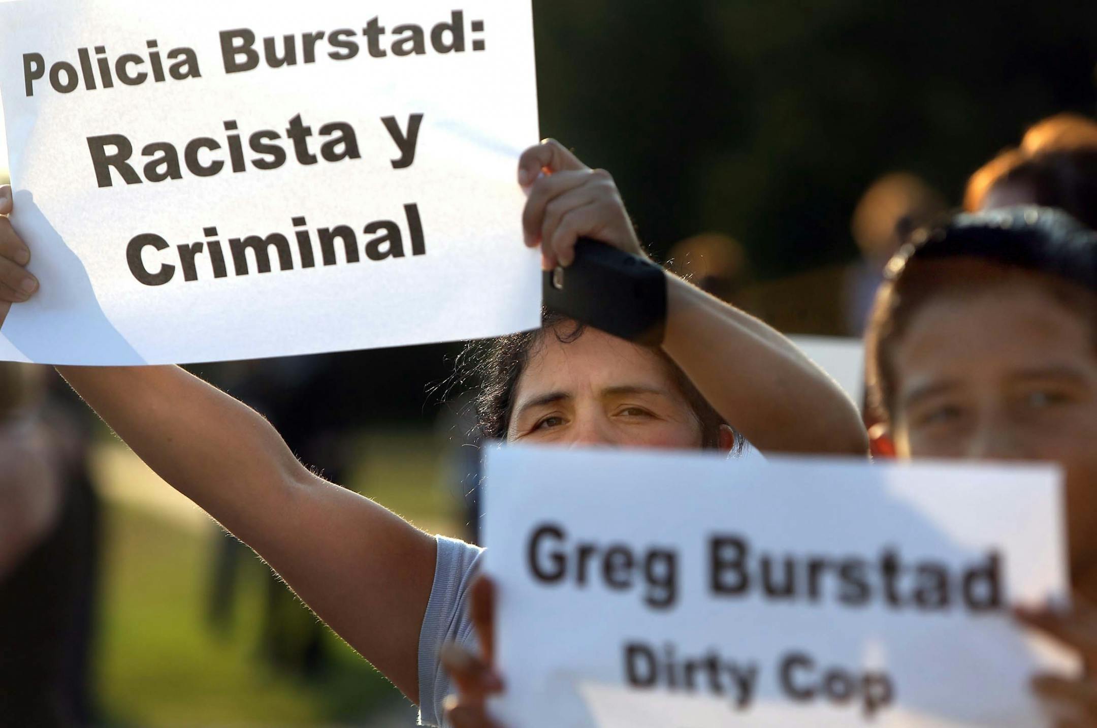 Antonia Alvarez (middle), St. Anthony, was among those gathered in front of the Brooklyn Park Police Station to voice her concerns. Several dozen protestors, including those from the Communities United Against Police Brutality (CUAPB) and the Latino civil rights organization Asamblea de Derechos Civiles, gathered outside the Brooklyn Park Police Department to voice their concerns about officer Greg Burstad, who they say has engaged in a pattern of misconduct, brutality and criminal acts against