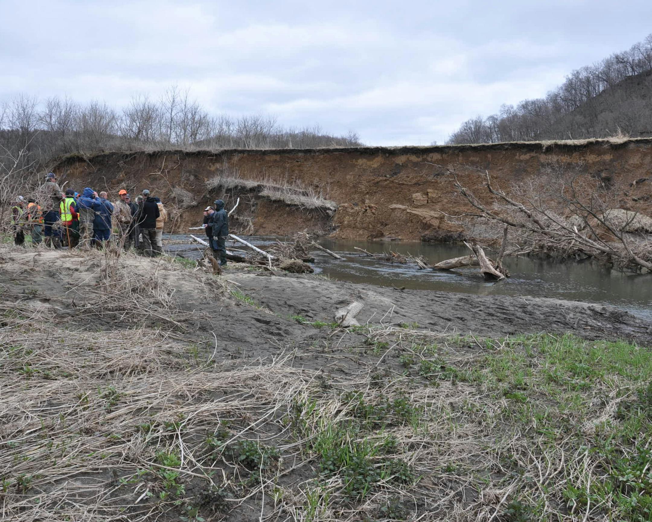 A group of state officials and Driftless Area trout stream conservations inspect slope damage in the Rushford area caused by spring flooding. Washouts are prompting a durability review of state habitat improvement projects on Southeastern streams.