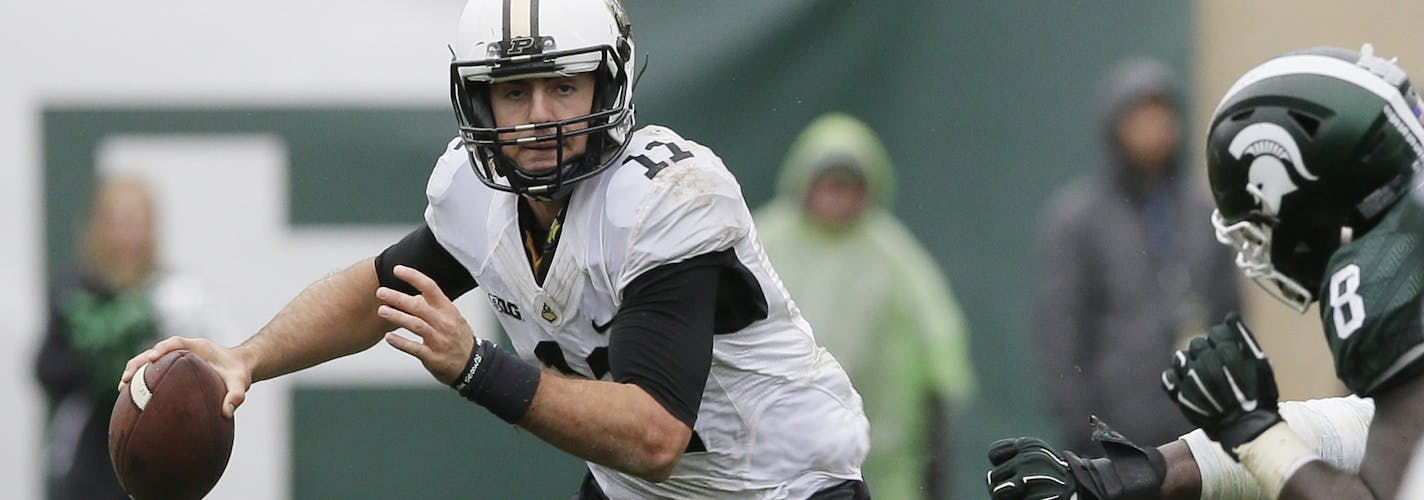 Purdue quarterback David Blough (11) scrambles during the second half of an NCAA college football game against Michigan State, Saturday, Oct. 3, 2015, in East Lansing, Mich. (AP Photo/Carlos Osorio)