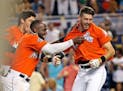 Miami’s JT Riddle (39) celebrated his walk-off home run with teammates Marcell Ozuna (13) and Christian Yelich (21) on April 16, 2017.