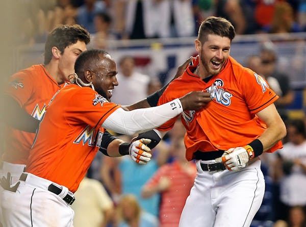 Miami’s JT Riddle (39) celebrated his walk-off home run with teammates Marcell Ozuna (13) and Christian Yelich (21) on April 16, 2017.