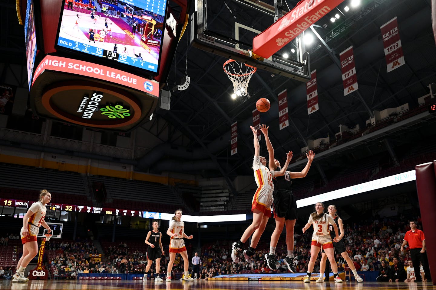Mountain Iron-Buhl and BOLD tangle under the Williams Arena scoreboard during the Class 1A championship game in 2023.