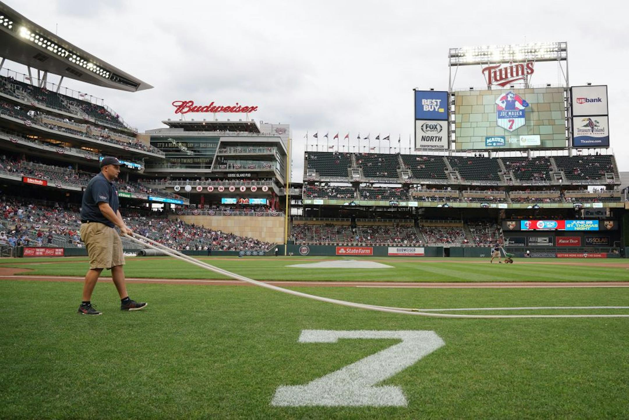 Grounds crews prepped the infield ahead of Saturday's ceremony to retire former star Joe Mauer's number 7 at Target Field.