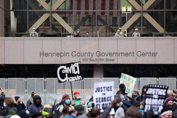People gathered April 20 outside the Hennepin County Government Center in downtown Minneapolis waiting for the verdict in the murder trial of former M