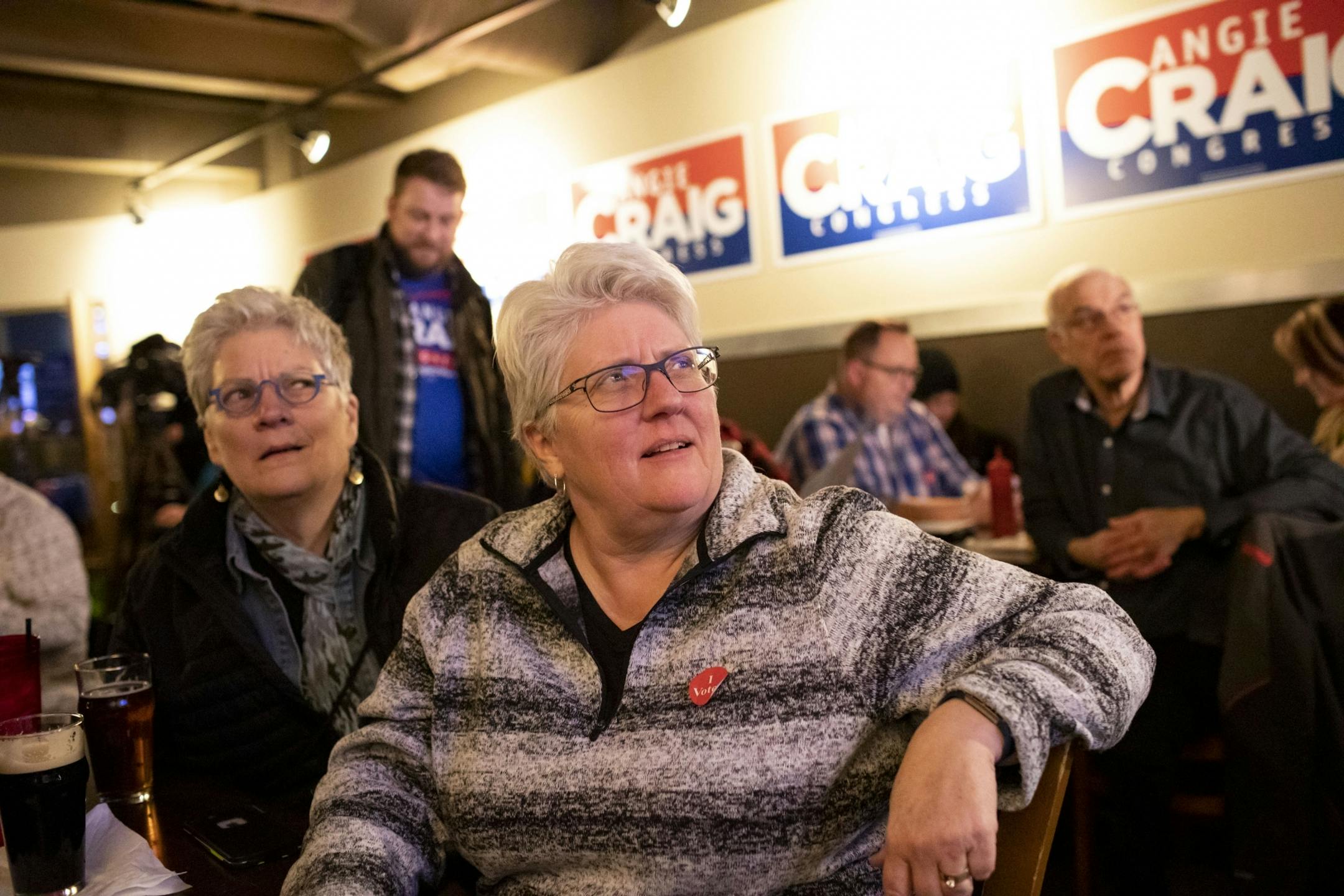 Peg Lonnquist and her wife Celeste Culberth, right, watched election results on the television early on at an election party for Angie Craig on Tuesday, November 6, 2018, at the Lone Oak Grill in Eagan, Minn.