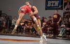 Devin Skatzka (right, shown in a January match against Rutgers) and the Gophers rode seven bonus-point victories and two pins to its first Big Ten shu