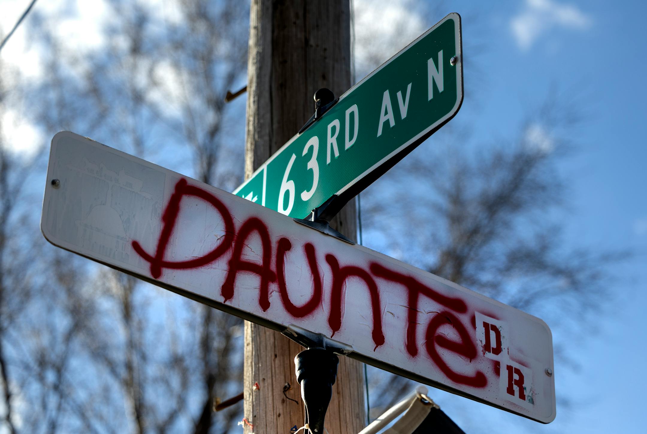 A sign with the name Daunte Dr. at 63rd Avenue north at a Vigil honoring Daunte Wright on one-year anniversary of his death Monday, April 11, in Brooklyn Center, Minn.