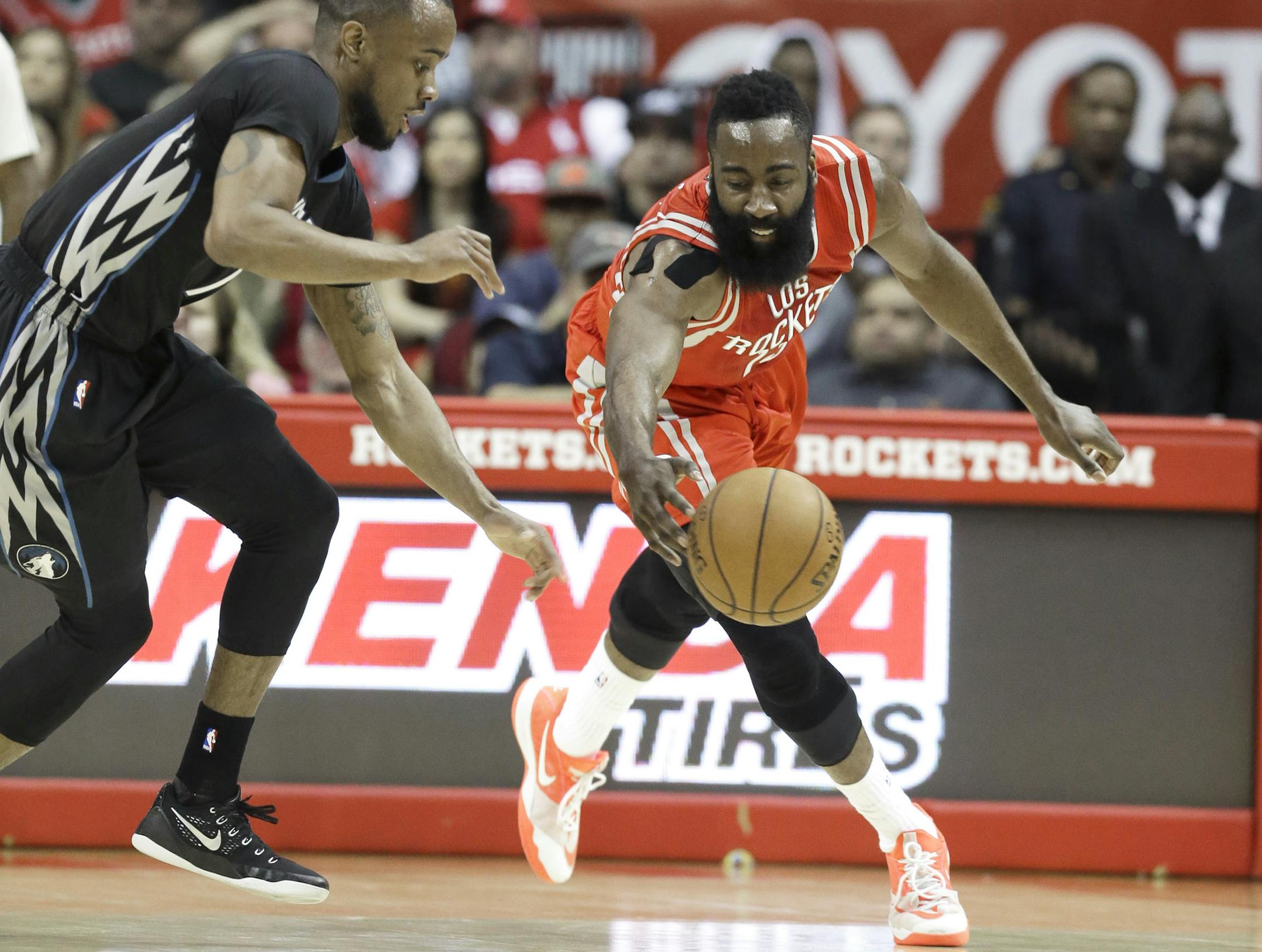 Minnesota Timberwolves' Lorenzo Brown, left, and Houston Rockets' James Harden chase a loose ball in the first half of an NBA basketball game Friday, March 27, 2015, in Houston. (AP Photo/Pat Sullivan)