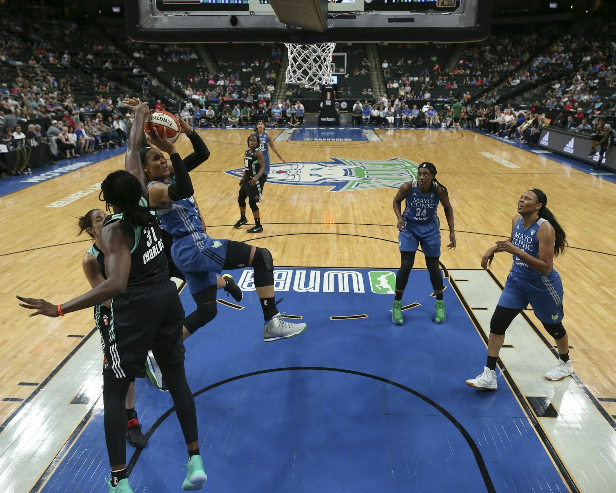 Minnesota Lynx forward Maya Moore (23) got first half shot off despite the triple team by Liberty center Tina Charles (31), Kiah Stokes (41) and Rebecca Allen (9) in the first half.