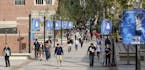 FILE - In this Feb. 26, 2015, file photo, students walk on the University of California, Los Angeles campus. Federal authorities have charged college 