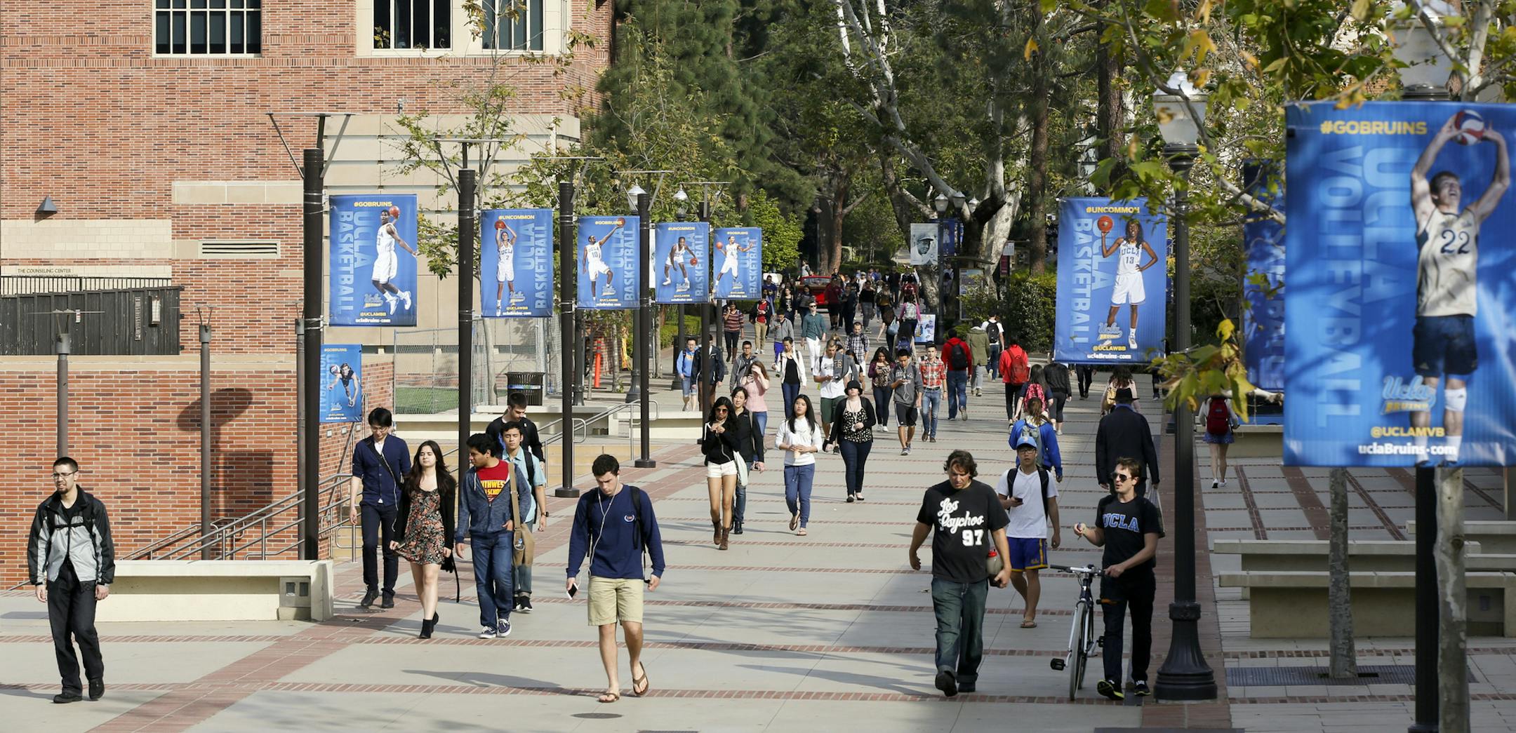 FILE - In this Feb. 26, 2015, file photo, students walk on the University of California, Los Angeles campus. Federal authorities have charged college coaches and others in a sweeping admissions bribery case in federal court. The racketeering conspiracy charges were unsealed Tuesday, March 12, 2019, against coaches at schools including UCLA, Wake Forest, Stanford, Georgetown, and the University of Southern California. (AP Photo/Damian Dovarganes, File)
