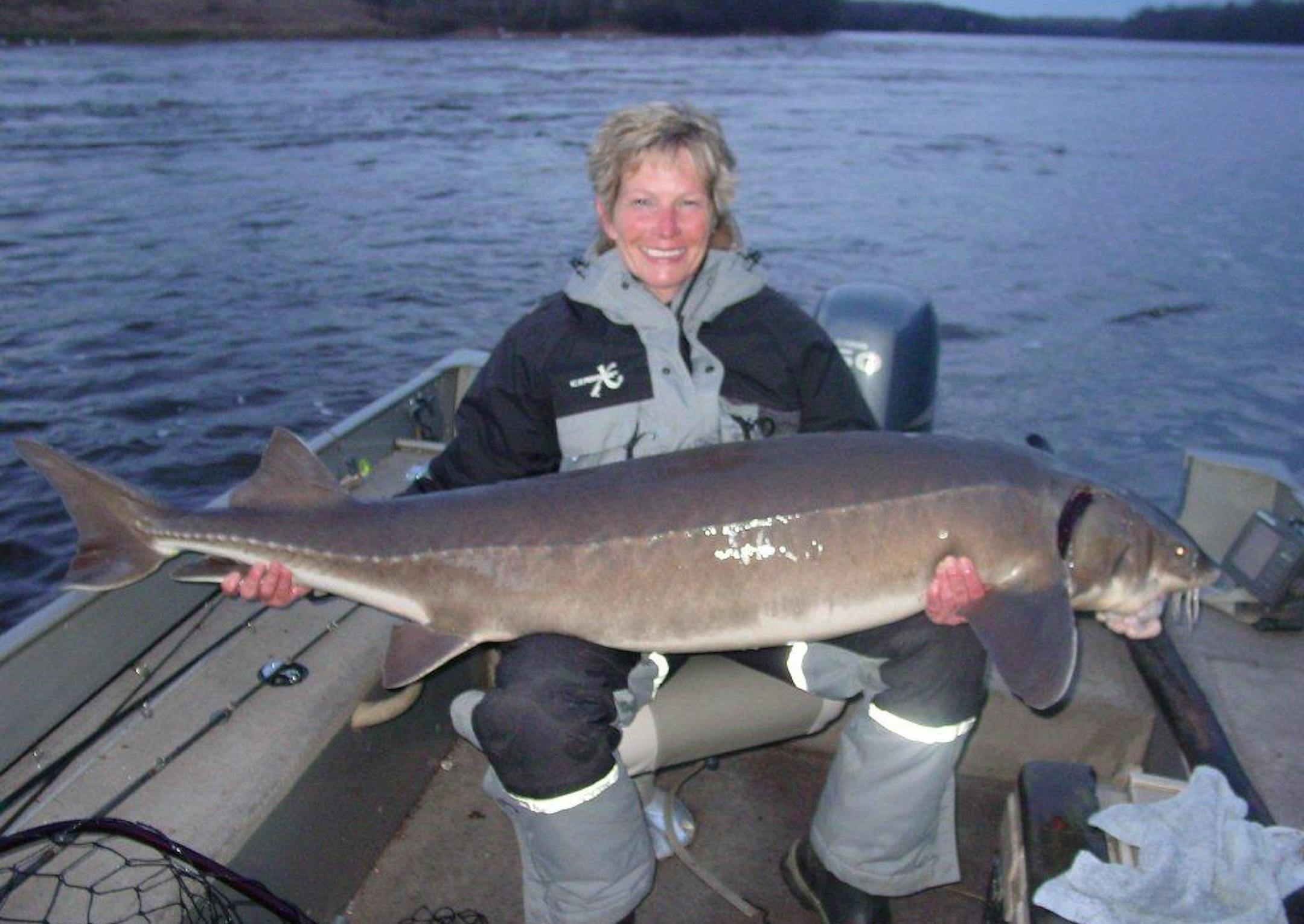 Julie Peterson with a 68 1/4 inch sturgeon caught on Rainy River.