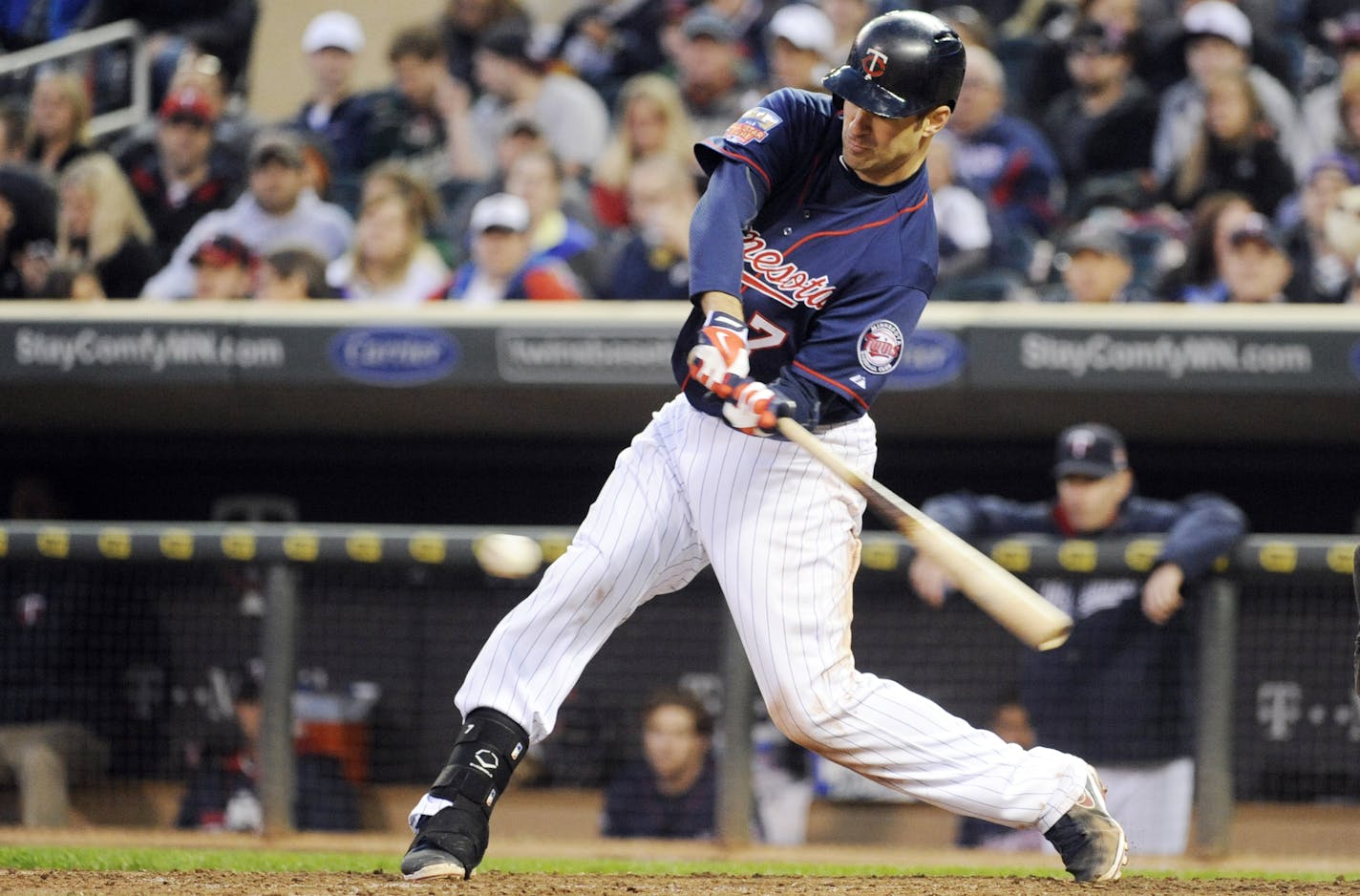 Minnesota Twins Joe Mauer (7) swings against Boston Red Sox starting pitcher Jake Peavy on during a baseball game in Minneapolis, Tuesday, May, 13, 2014.(AP Photo/Craig Lassig)