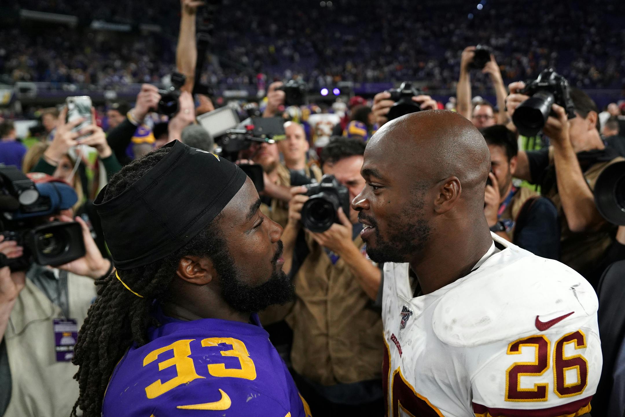 Vikings running back Dalvin Cook (33) talked with Redskins running back and former Vikings star Adrian Peterson (26) after the teams' Oct. 24 meeting.
