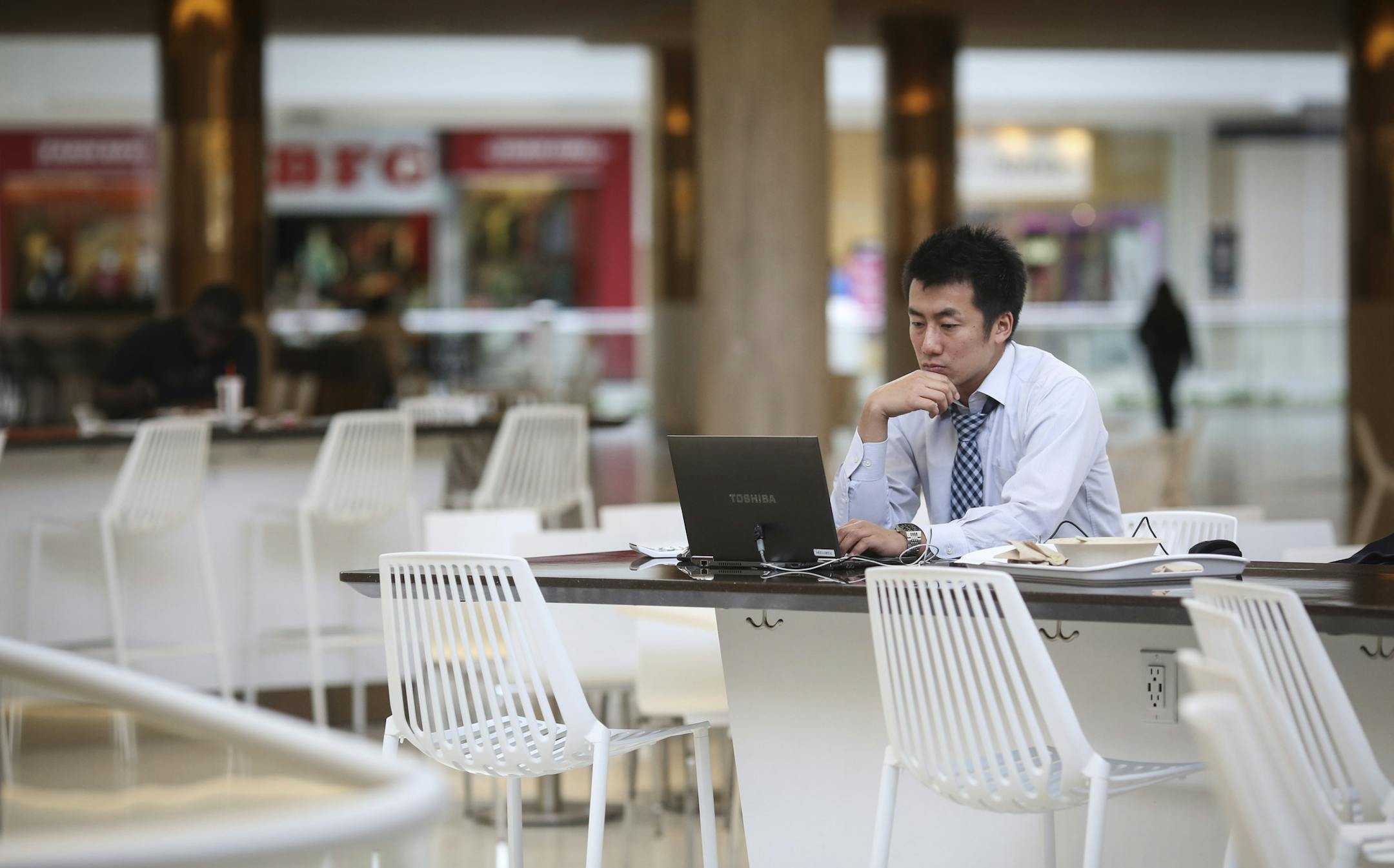 Masaya Tsuchida worked on his laptop using the internet from his iphone in the new food court at the Mall of America in Bloomington, Minn., on Tuesday, October 27, 2015. ] RENEE JONES SCHNEIDER • reneejones@startribune.com Soon wireless will be available in the Mall of America