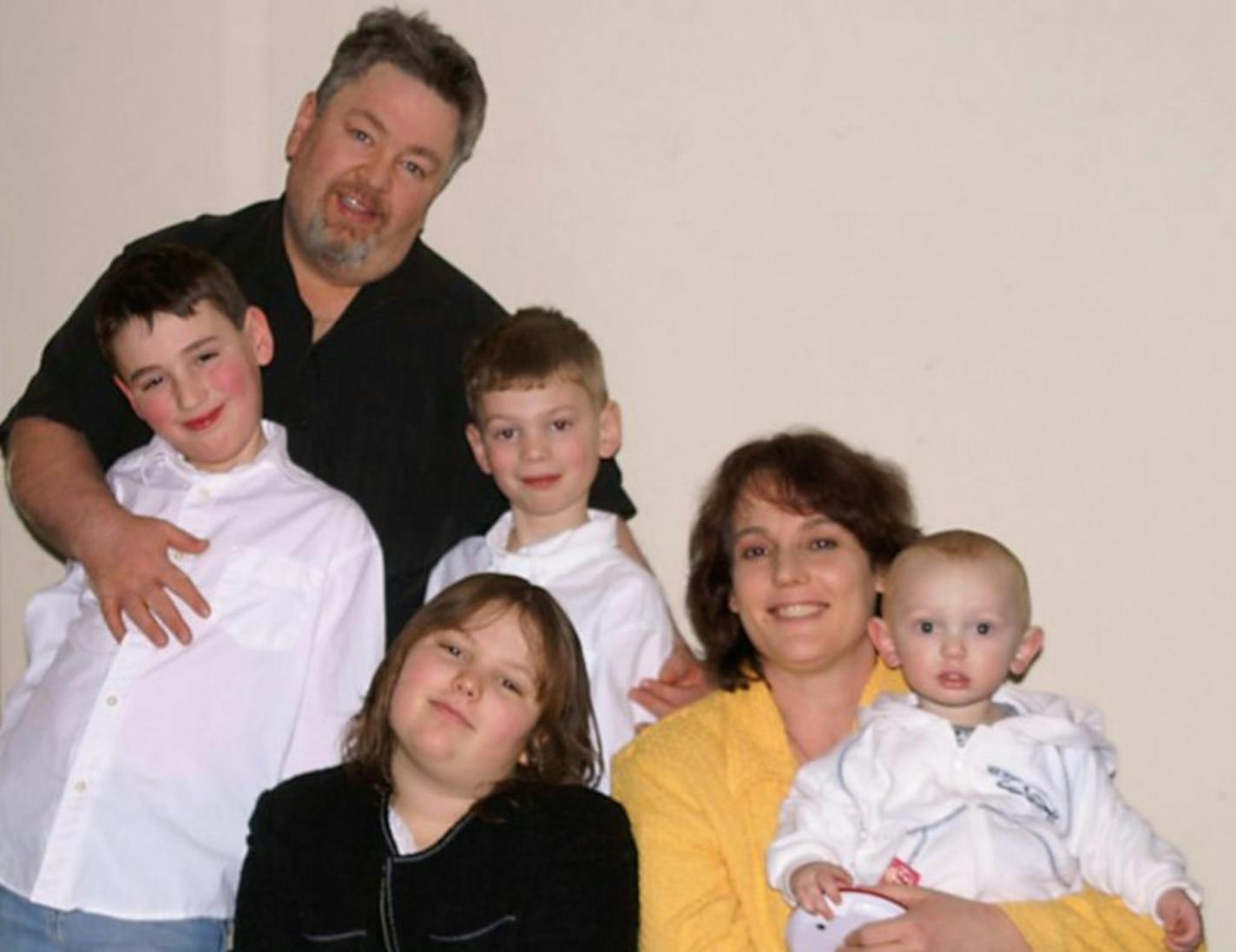 The McDonough family paid off $123,000 in debt and $25,000 in medical expenses in just 2.5 years. Here they are with their kids Robbie, 10, Maggie, 12, Max, 8 and Remy 1.5 in February 2011. Photo courtesy of the family.