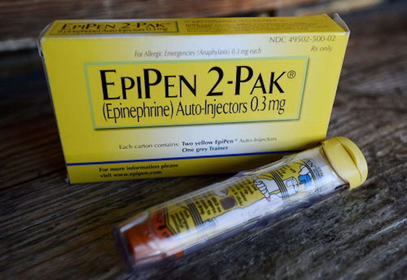 FILE - This Oct. 10, 2013, file photo, shows an EpiPen epinephrine auto-injector, a Mylan product, in Hendersonville, Texas. Facing public furor for the price of its emergency allergy shot EpiPen, Mylan Pharmaceuticals quickly pointed to a familiar industry solution: copay discount cards. Discount cards for EpiPen and other pricey drugs can help consumers lower their pharmacy costs. But don't call them a solution to skyrocketing drug prices, experts say. (AP Photo/Mark Zaleski, File)