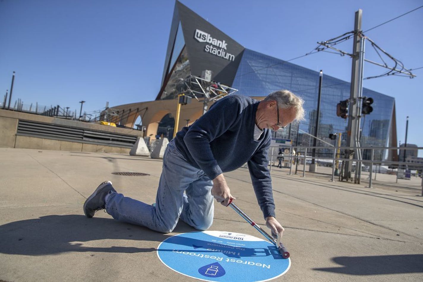 Steve Wortman placed "Nearest Restroom," signs on downtown sidewalks, Thursday, October 17, 2019 in Minneapolis, MN. Minneapolis businesses and city officials are trying to increase the number of public places downtown where people can use a bathroom. "Access to high-quality restrooms downtown is a universal concern," said Steve Cramer, President & CEO of the Mpls Downtown Improvement District.