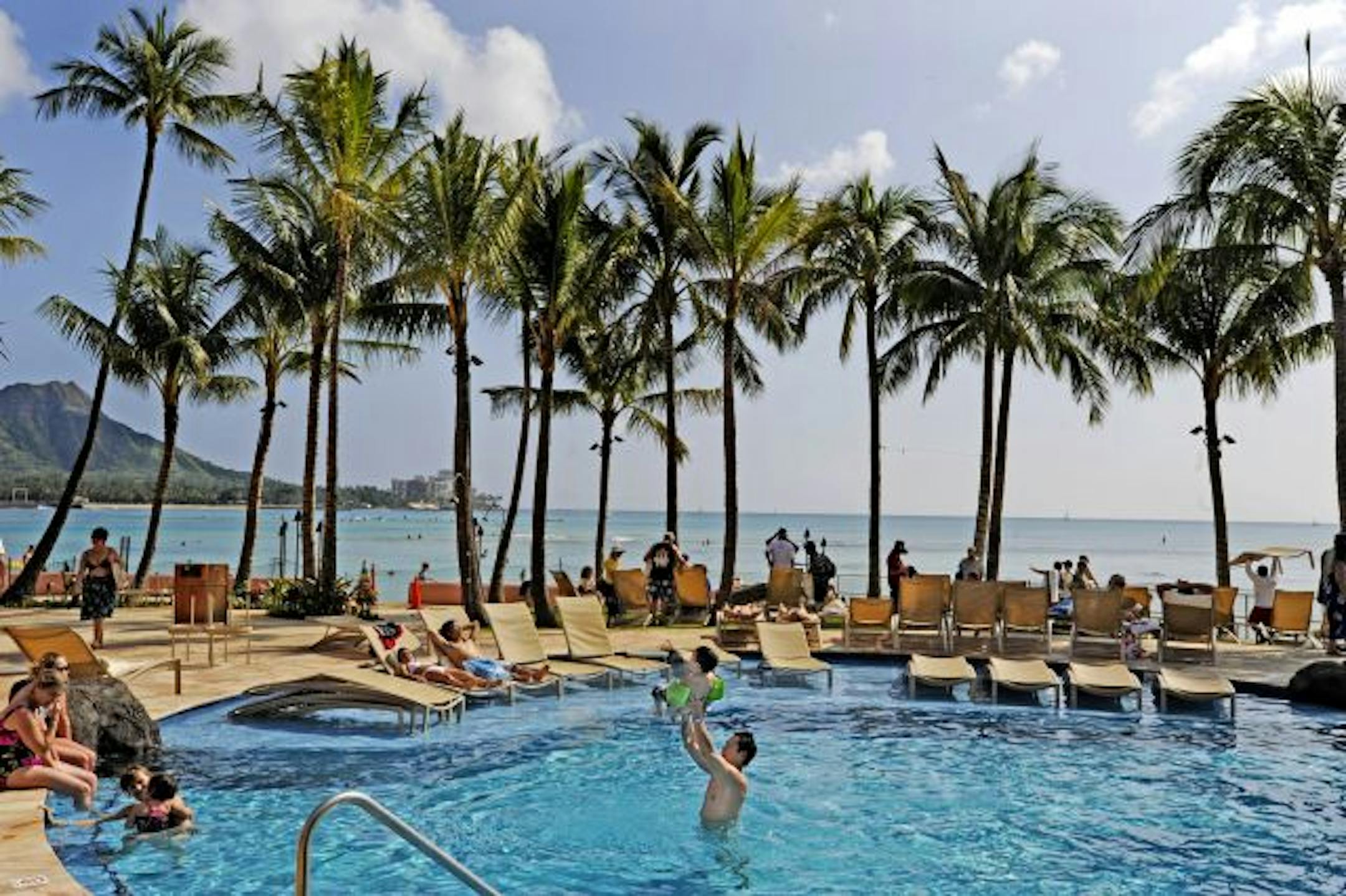 Rob Chan plays with his son Tyler, 4, at the newly renovated Royal Hawaiian in Waikiki on Oahu Island, Hawaii.
