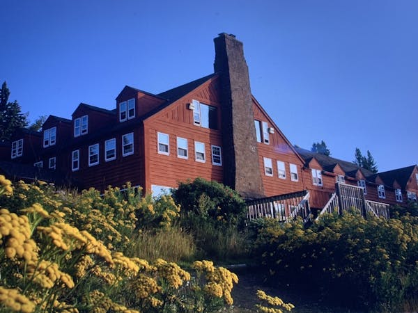 A summer view of the Mesaba Red-painted Lutsen Lodge from the cobblestone beach.