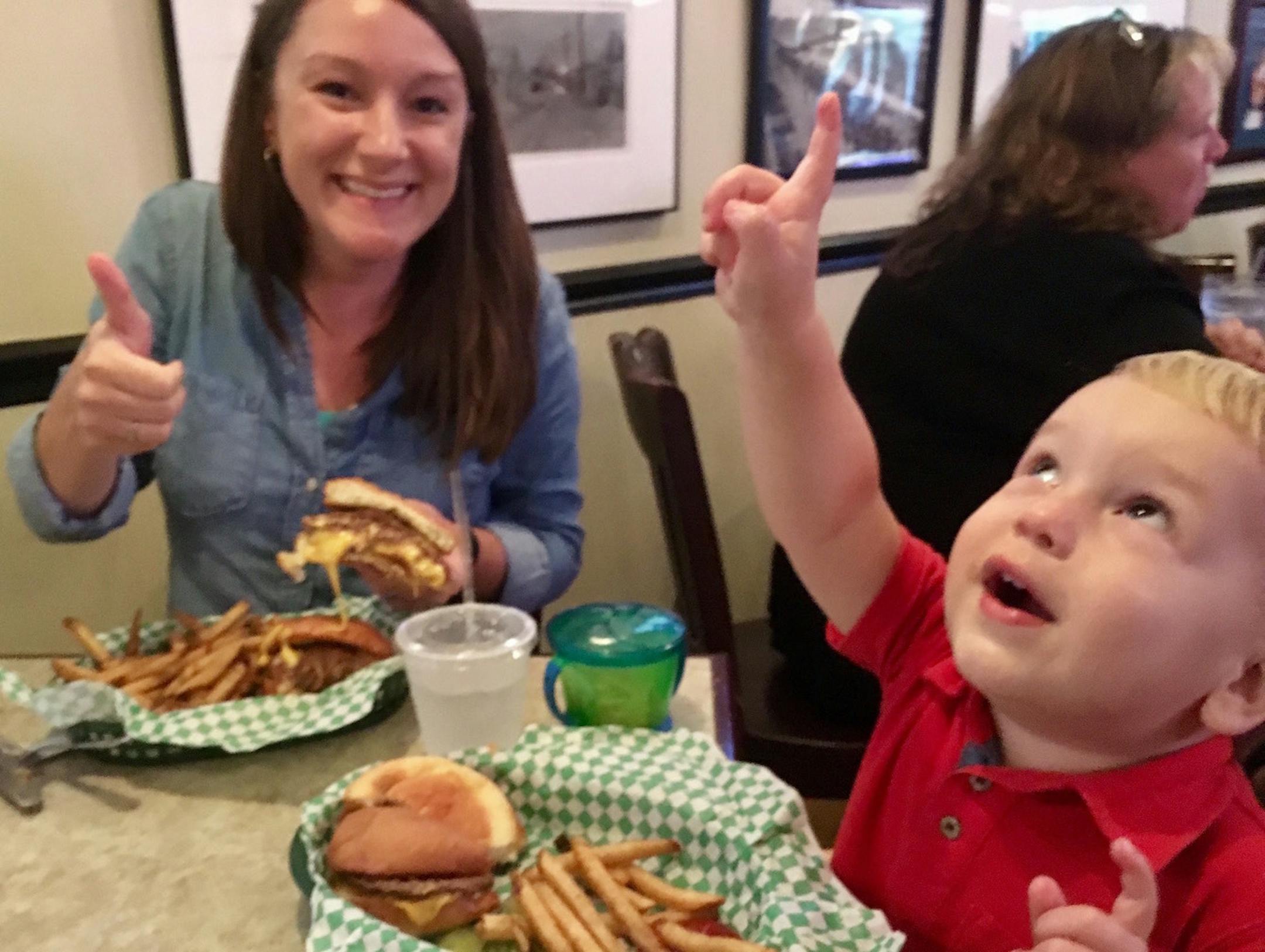 Aly Nelson and son Jack learn that Aly is pregnant with a girl, based on the cheese in her juicy lucy on an August 2017 meal at the Nook. Courtesy Eric Nelson