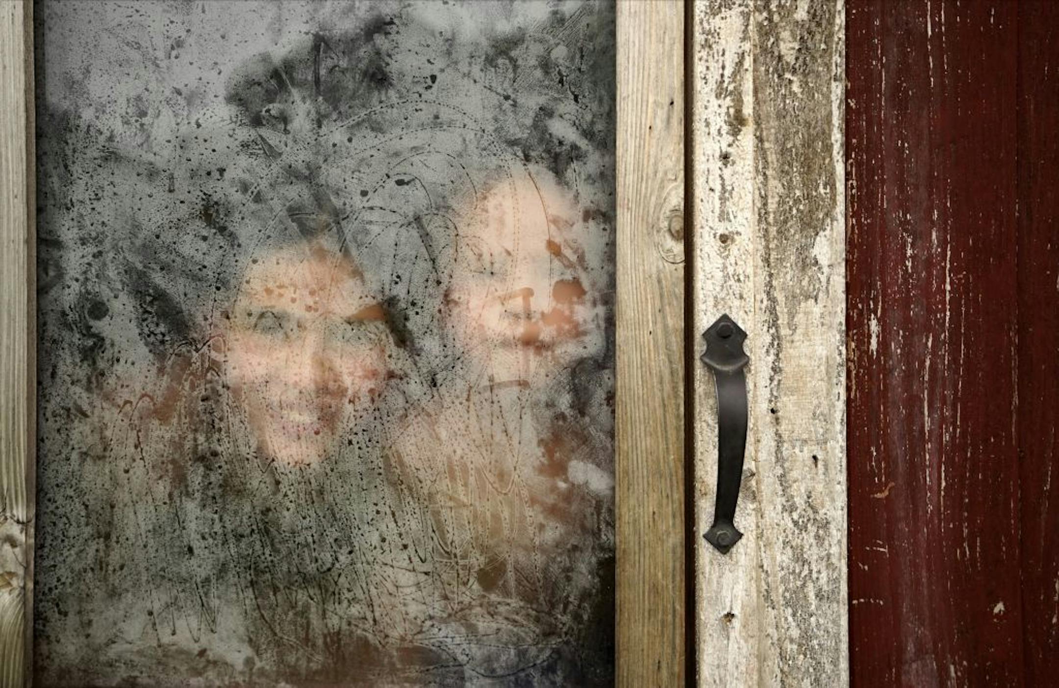 A pair of Rice children peek through the steam.