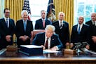 U.S. President Donald Trump signs H.R. 748, the CARES Act in the Oval Office of the White House on March 27, 2020 in Washington, D.C. Earlier on Frida