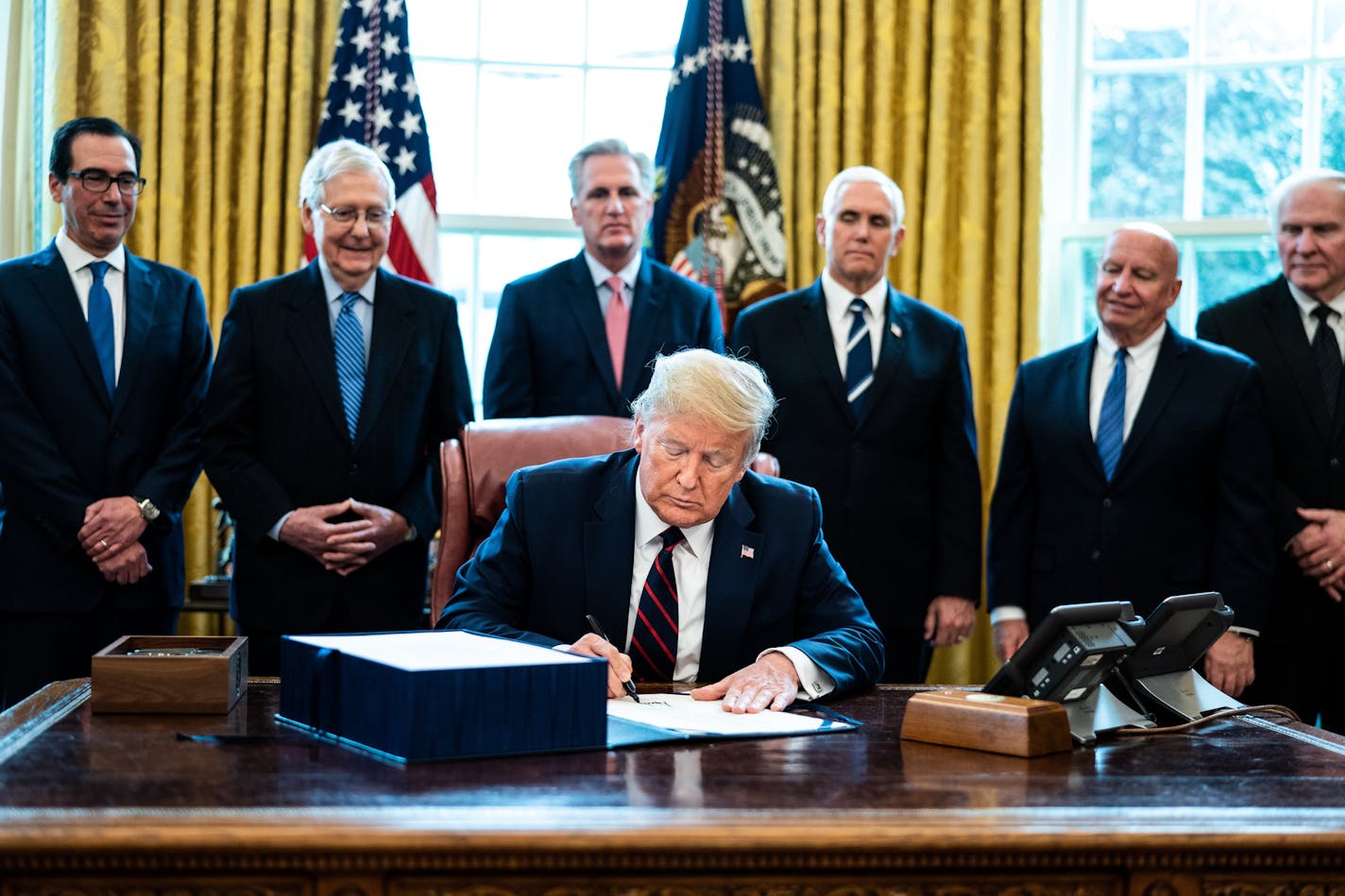 U.S. President Donald Trump signs H.R. 748, the CARES Act in the Oval Office of the White House on March 27, 2020 in Washington, D.C. Earlier on Friday, the U.S. House of Representatives approved the $2 trillion stimulus bill that lawmakers hope will battle the the economic effects of the COVID-19 pandemic. (Erin Schaff/Pool/Getty Images/TNS) ORG XMIT: 1621652