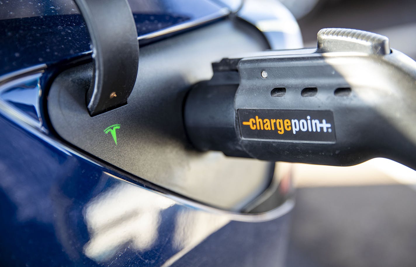 A small green light blinked on George Host's Tesla while it charged at the ChargePoint charging station near Canal Park Lodge in Duluth.