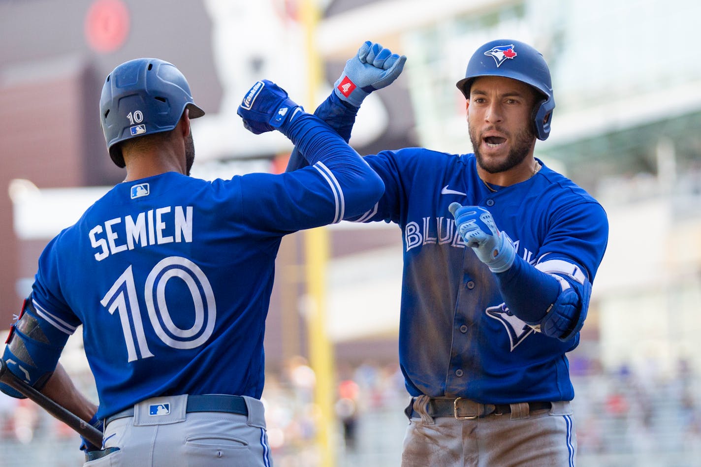 Toronto Blue Jays' George Springer, right, celebrates his home run with Marcus Semien in the fifth inning of a baseball game against the Minnesota Twins, Sunday, Sept. 26, 2021, in St. Paul, Minn. (AP Photo/Andy Clayton-King)