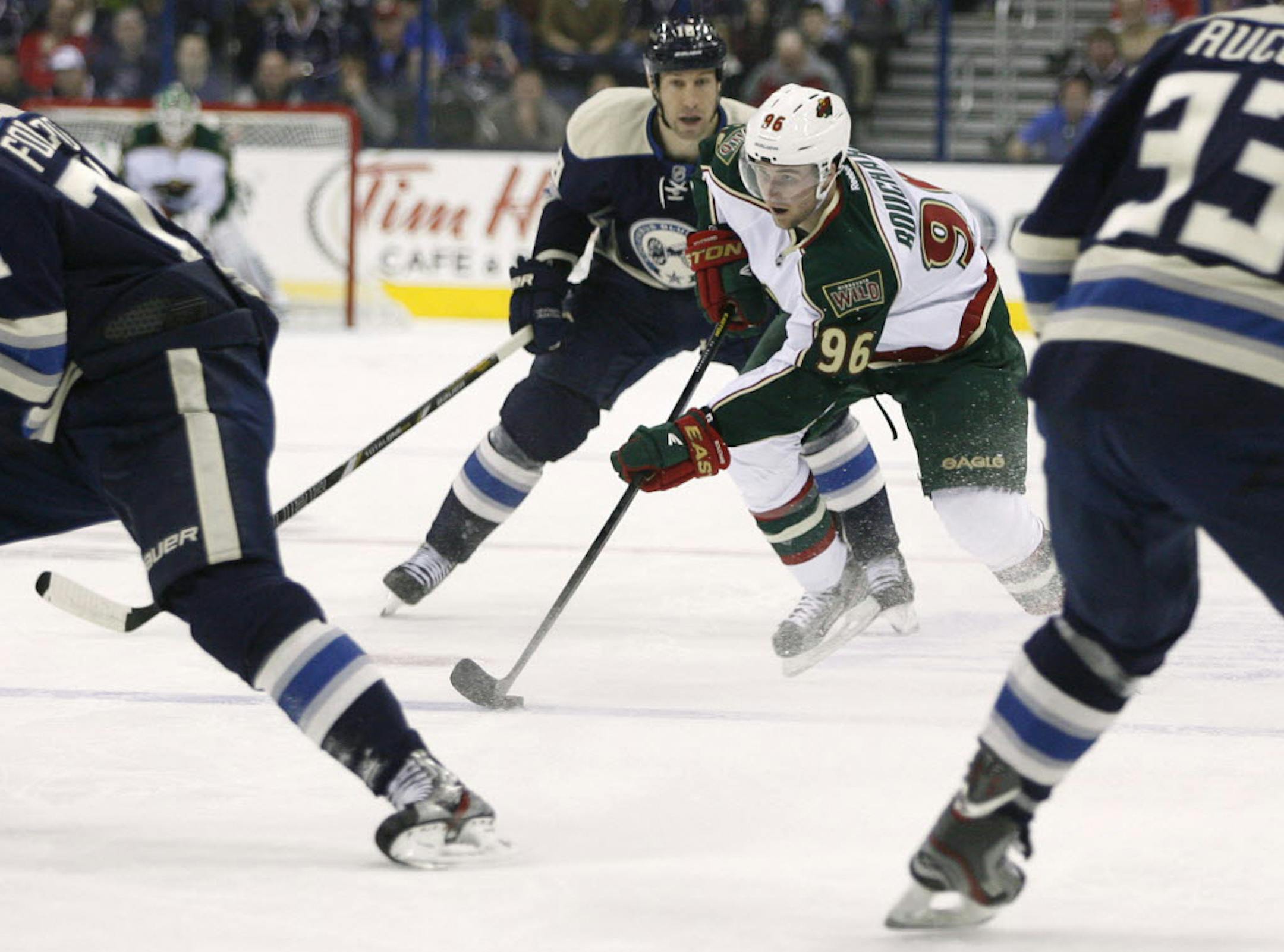 Minnesota's Pierre-Marc Bouchard (96) weavesdthrough the defense of the Columbus Blue Jackets.
