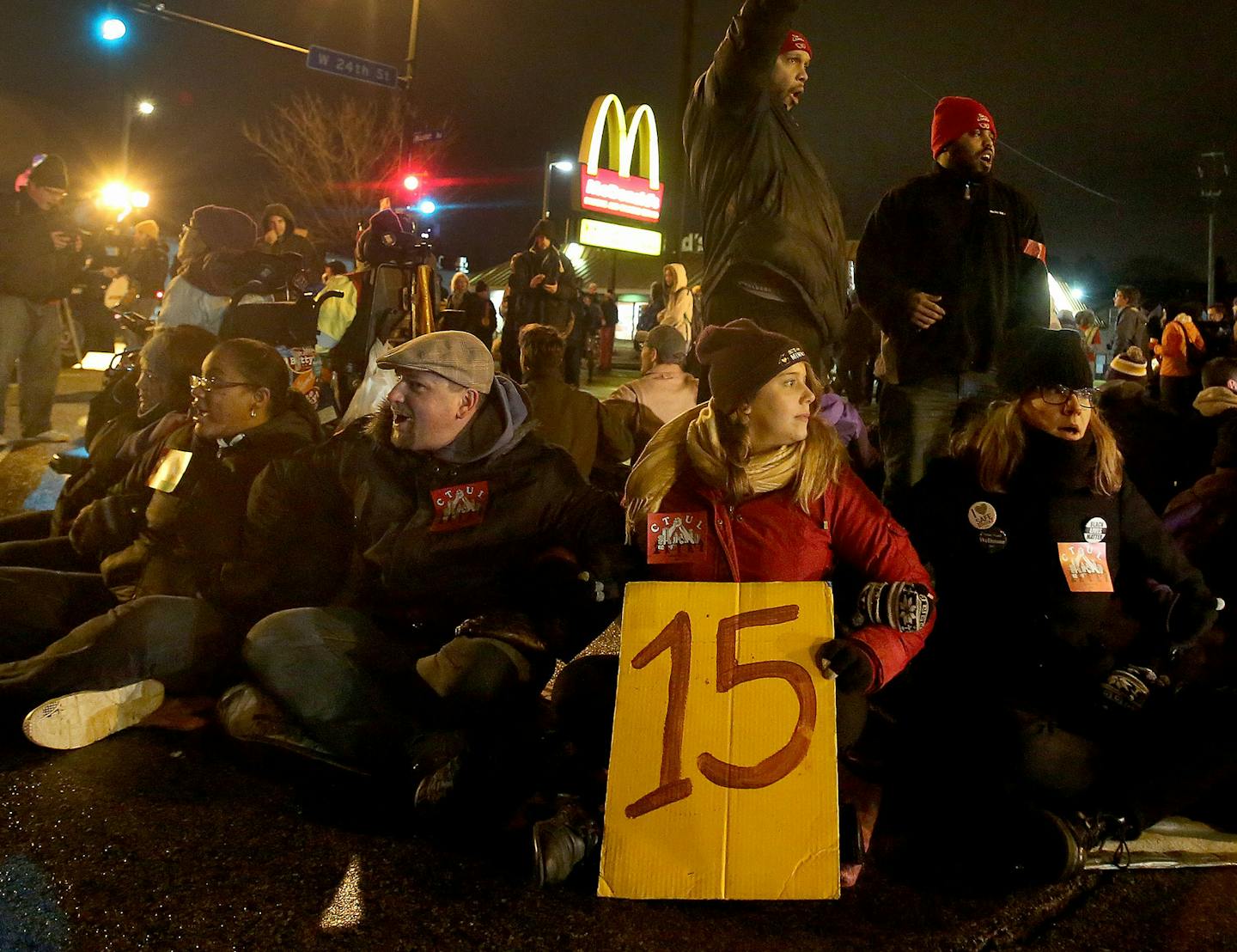 Protestors for Nationwide Fight for $15 Day of Disruption gathered outside McDonald's at 24th St. E. and Franklin Avenue, where for about a half hour protestors sat in a circle and blocked the intersection until they were arrested by Minneapolis police Tuesday, Nov. 29, 2016, in Minneapolis, MN. Here, Steven Suffridge raised his fist while standing with other protestors who blocked the intersection at 24th St. E. and Franklin Ave. before being taken into police custody. Those arrested were ticke