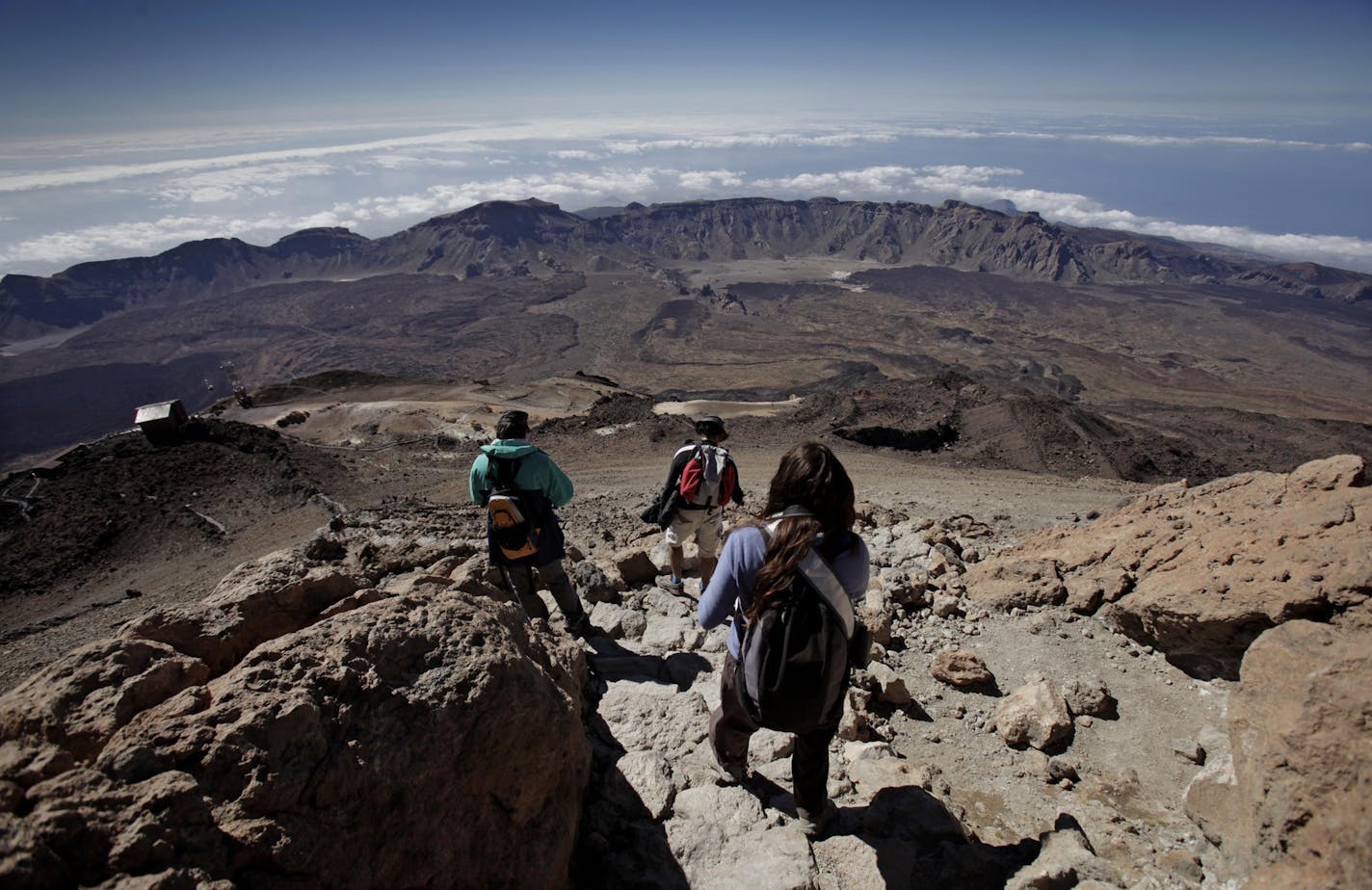 People climb the Teide volcano on September 15, 2012, at the Teide National Park in the Spanish Canary Island of Tenerife. AFP PHOTO / DESIREE MARTIN (Photo credit should read DESIREE MARTIN/AFP/GettyImages)