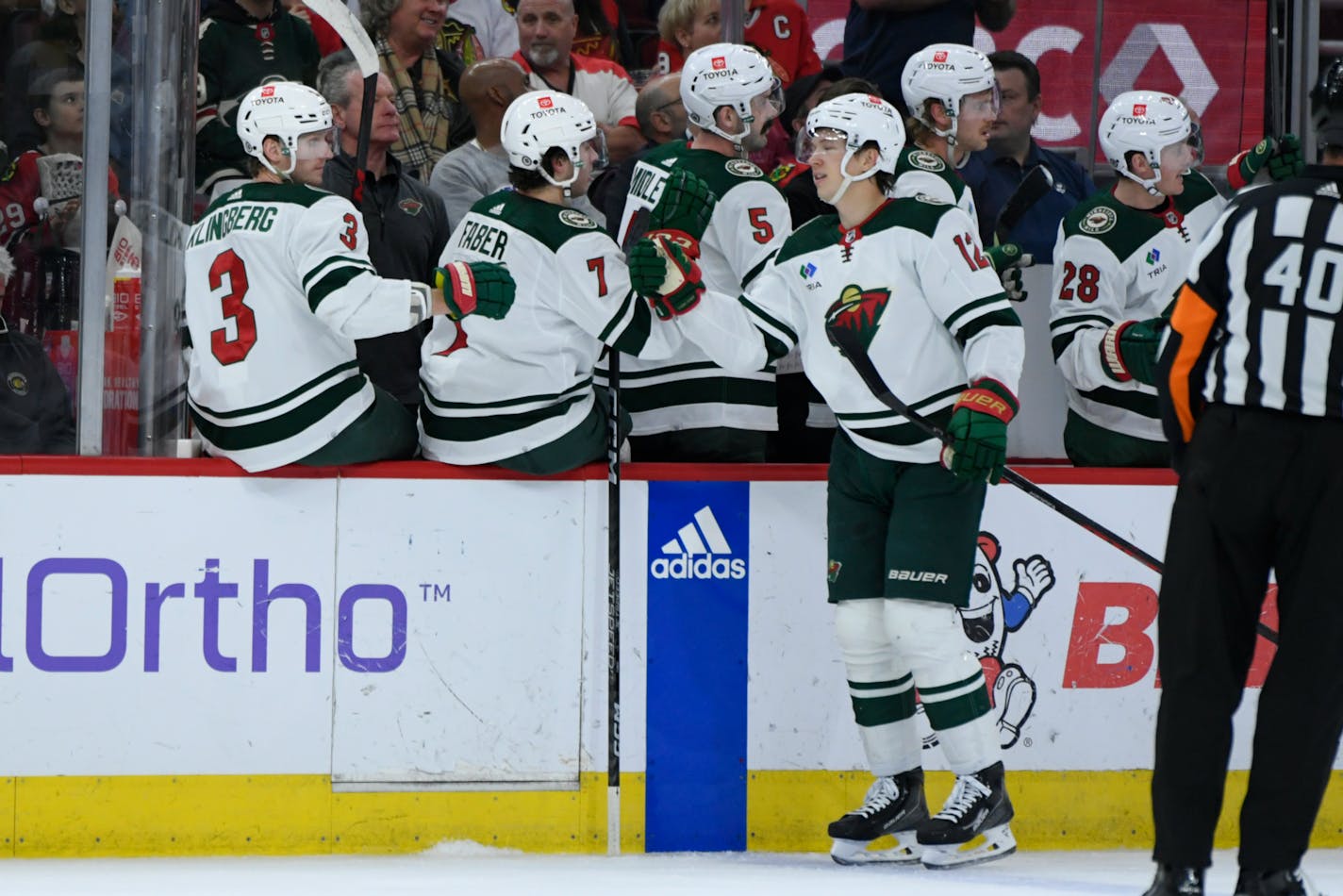 Minnesota Wild's Matt Boldy celebrates at the bench after scoring a goal during the first period of an NHL hockey game against the Chicago Blackhawks, Monday, April 10, 2023. (AP Photo/Paul Beaty)