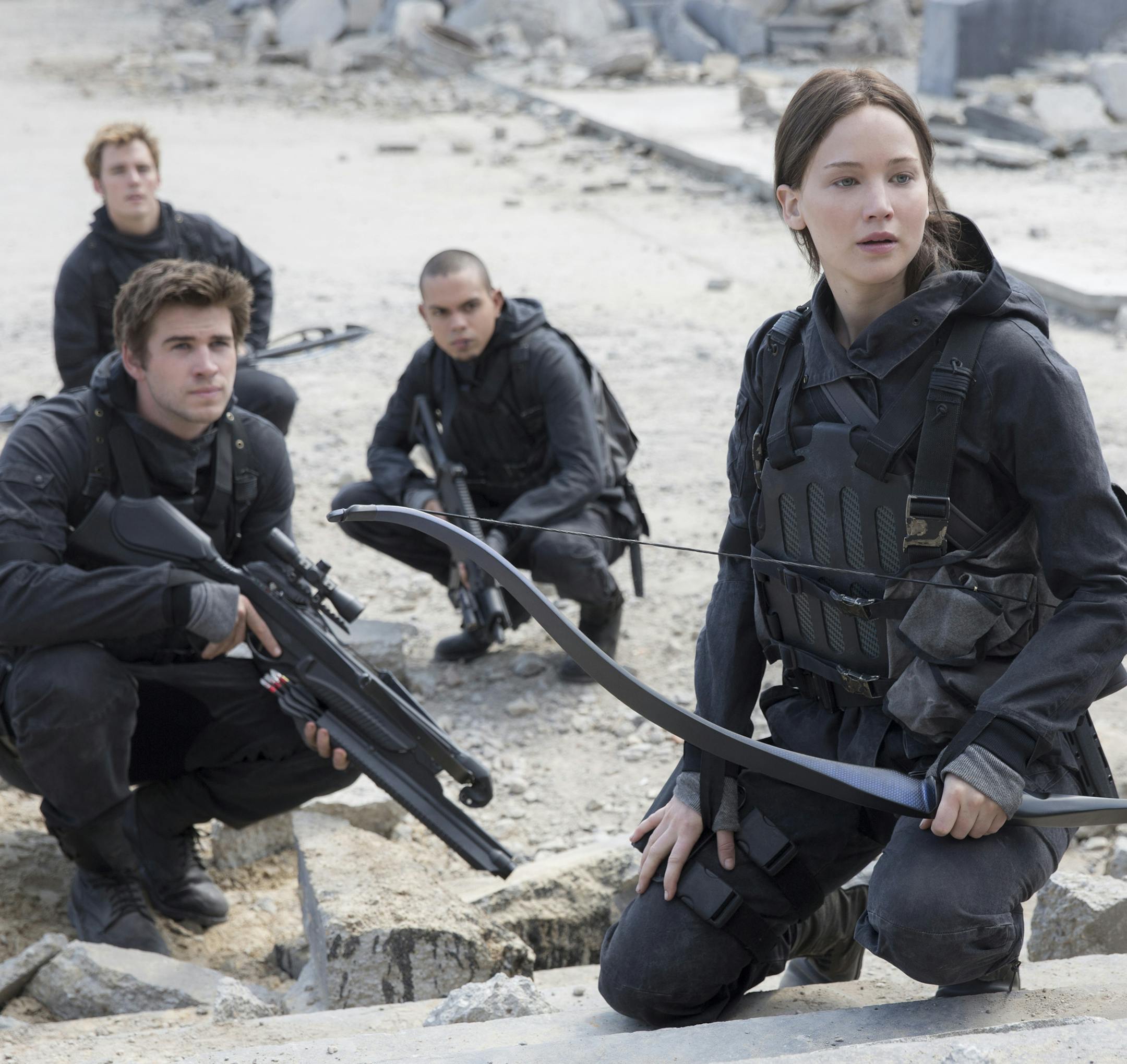 This photo provided by Lionsgate shows, Liam Hemsworth, left, as Gale Hawthorne, Sam Clafin, back left, as Finnick Odair, Evan Ross, back right, as Messalia, and Jennifer Lawrence, right, as Katniss Everdeen, in the film, "The Hunger Games: Mockingjay - Part 2." The movie opened in U.S. theaters on Nov. 20, 2015. (Murray Close/Lionsgate via AP)