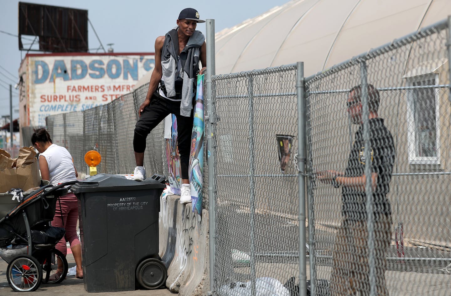 Long-time homeless encampment resident Ricky Robinson-Myers, 30, who was a resident of the Navigation Center until the previous day before getting an apartment stands outside the center talking to a security guard Friday, May 31, 2019, in Minneapolis, MN. Robinson-Myers said he has come back to the Navigation Center after moving out because it provides a sense of community with friends.] DAVID JOLES &#x2022; david.joles@startribune.com The Navigation Center is slated to close on Monday after sev