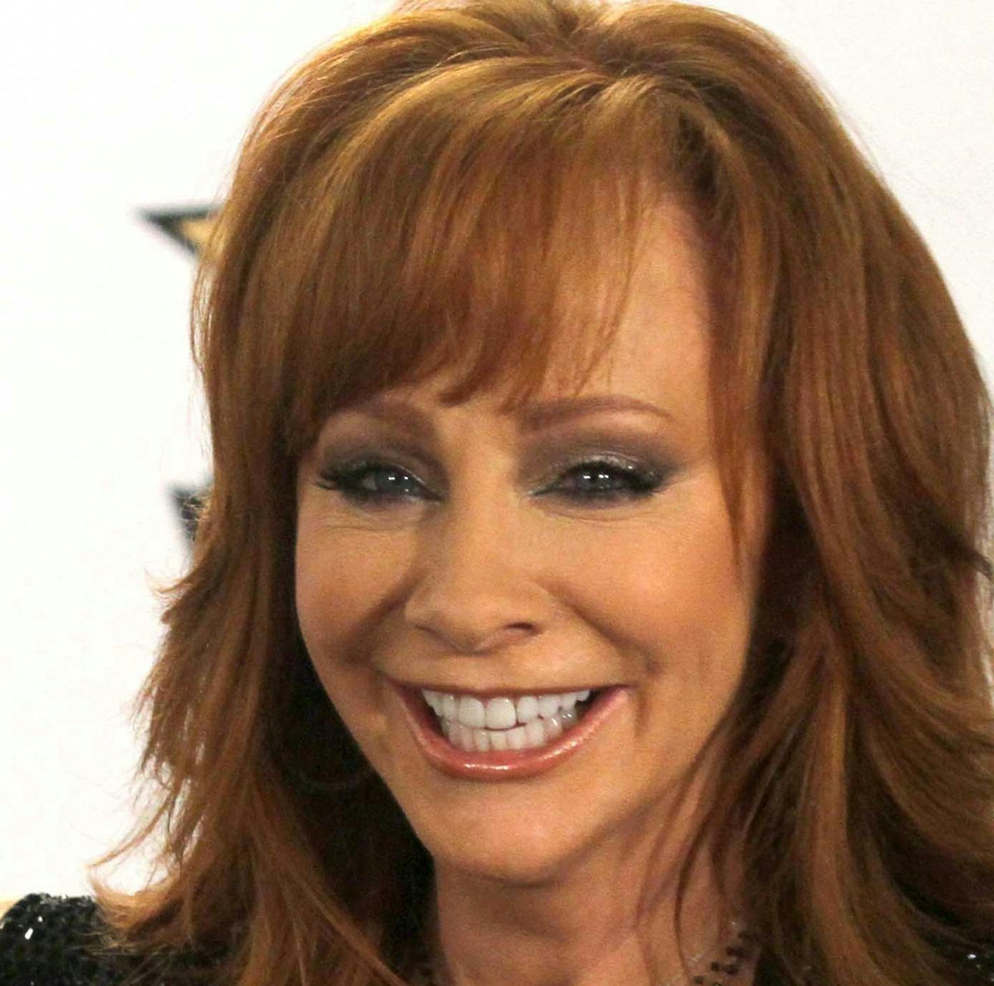 Reba McEntire poses in the press room with the milestone award at the 50th annual Academy of Country Music Awards at AT&T Stadium on Sunday, April 19, 2015, in Arlington, Texas. (Photo by Jack Plunkett/Invision/AP)