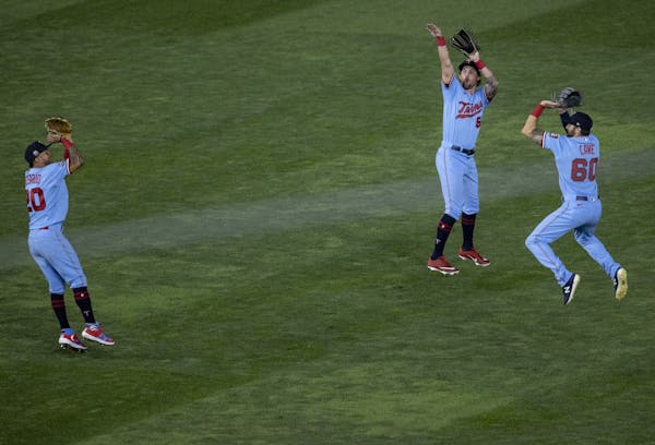 Minnesota Twins outfielders Eddie Rosario, Aaron Whitefield and Jake Cave celebrated at the end of the game.