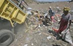 **ADVANCE FOR TUESDAY, SEPT. 8** This Aug. 26, 2009 photo shows people scavenging through a garbage dump in Dili, East Timor. A decade after its break