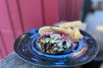 Beef and plantain arepa with Hola sauce tastes even better on a patio.