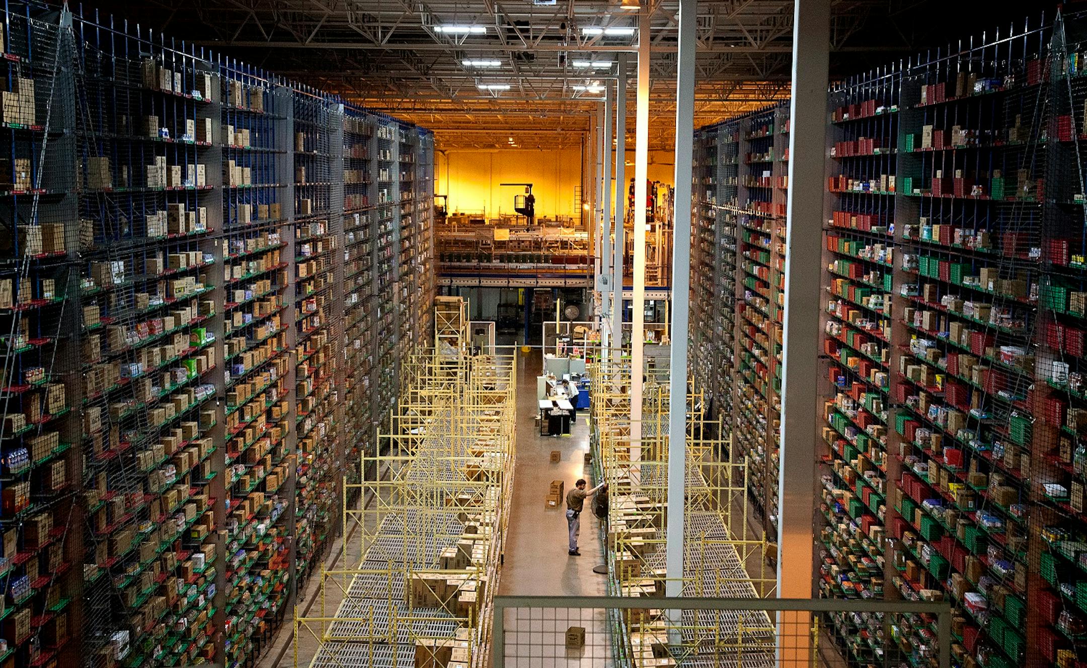 An employee at Supervalu Inc. stands in part of a warehouse at a distribution center in Hopkins, Minnesota on Monday, Jan. 9, 2012. Inventories at U.S. wholesalers rose 0.1 percent following a 1.2 percent revised gain in October, Commerce Department figures showed today in Washington. Photographer: Ariana Lindquist/Bloomberg